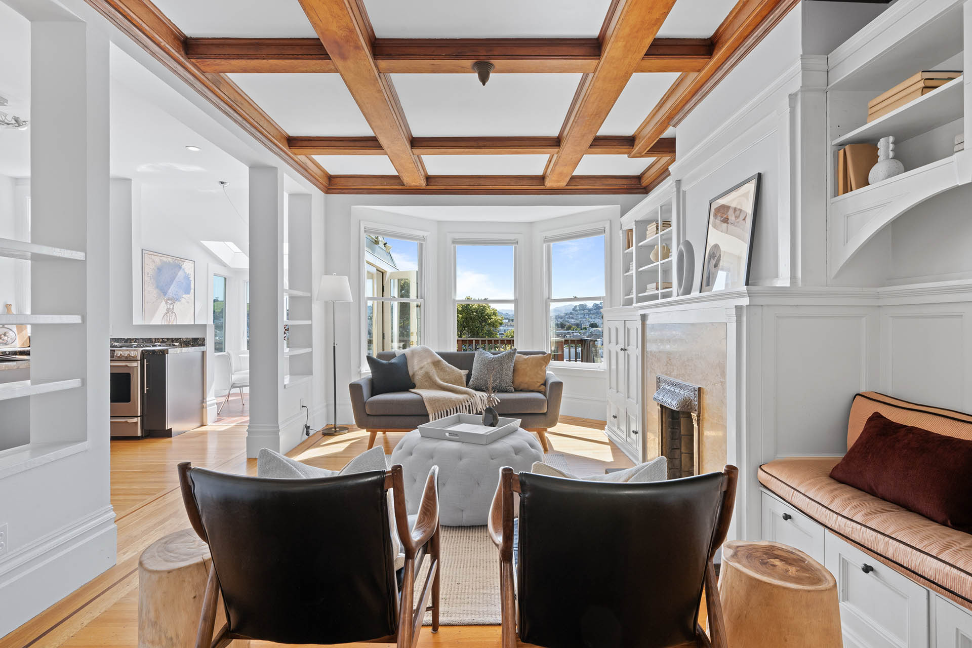 Looking into the back living room from dining room. Stunning original wood beam detail at ceilings.