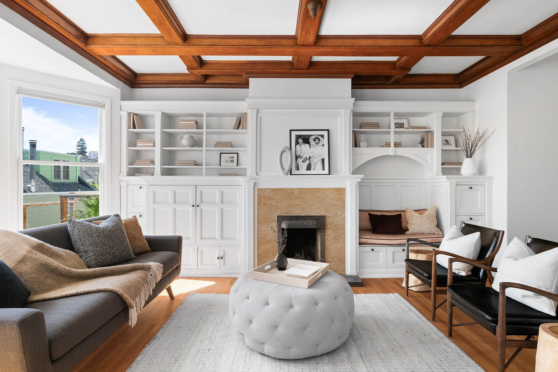 Back living room has hardwood floors throughout and built ins around the bookcase.