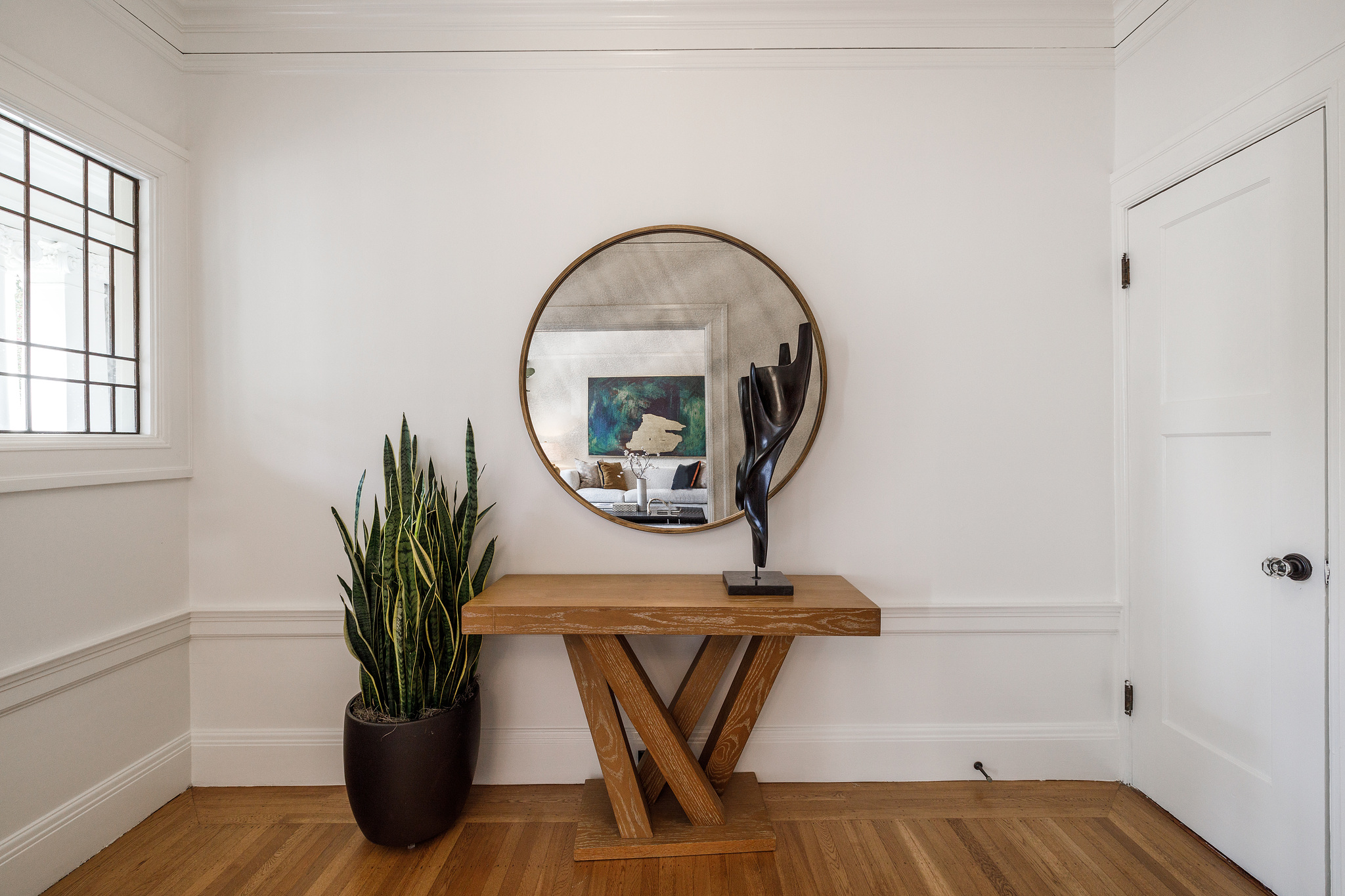 View of the entry area with white trim and wood floors