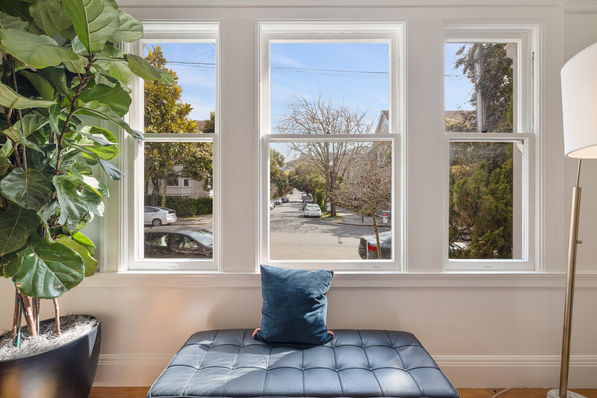 Close-up of the living room windows and view of the tree-lined street beyond