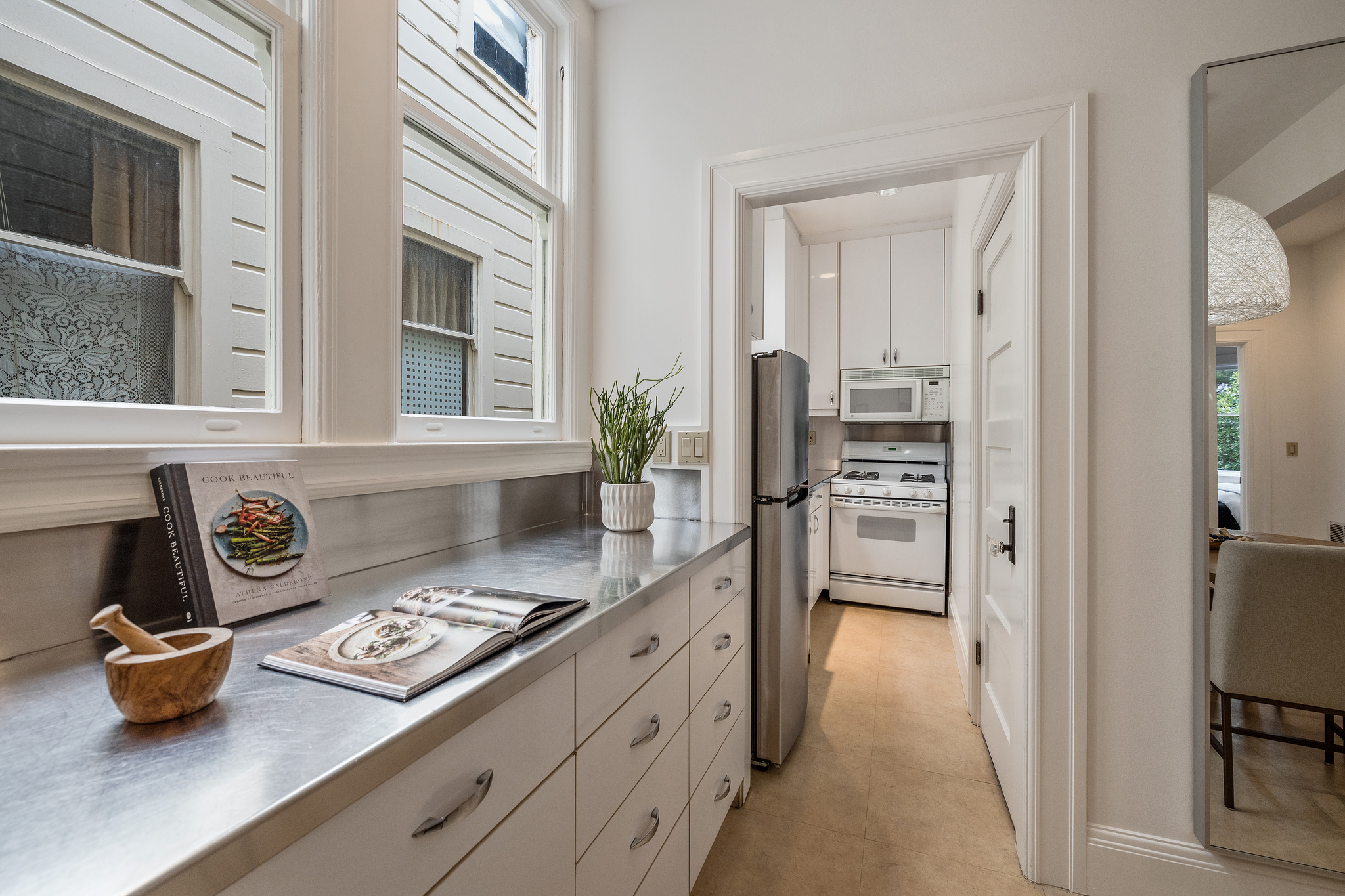 Kitchen, with white cabinets and galley style cooking area