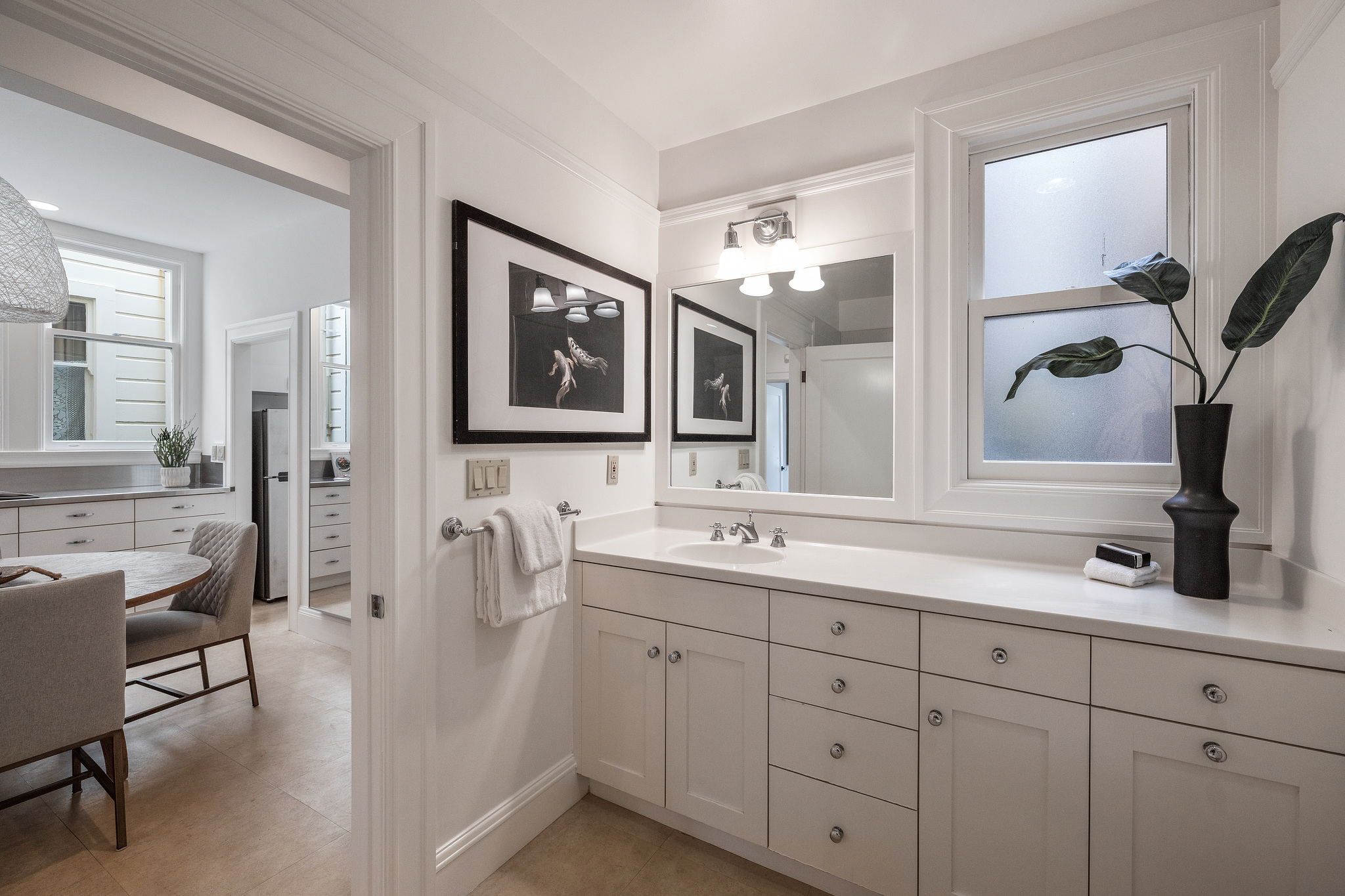 View of white cabinetry and a window