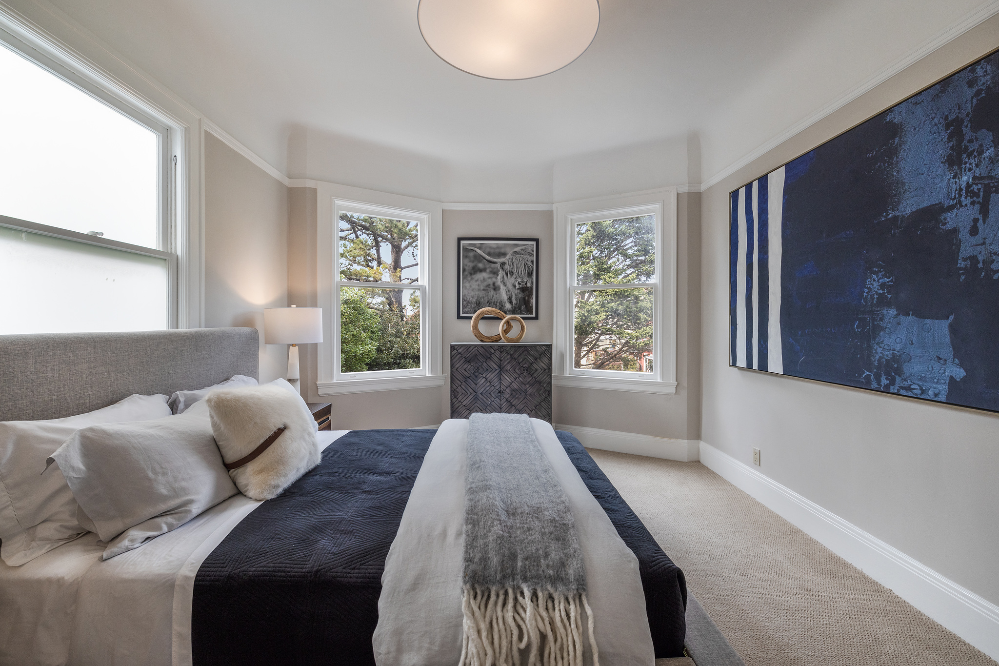 Long view of the bedroom with views of trees