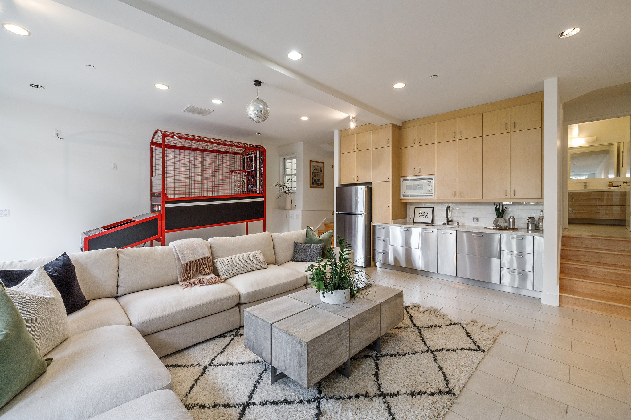 Lower living area with a view of cabinets and bar