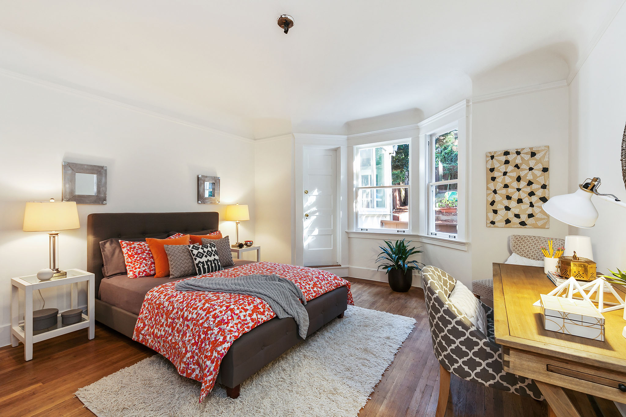 View of a bedroom with large windows and wood floor