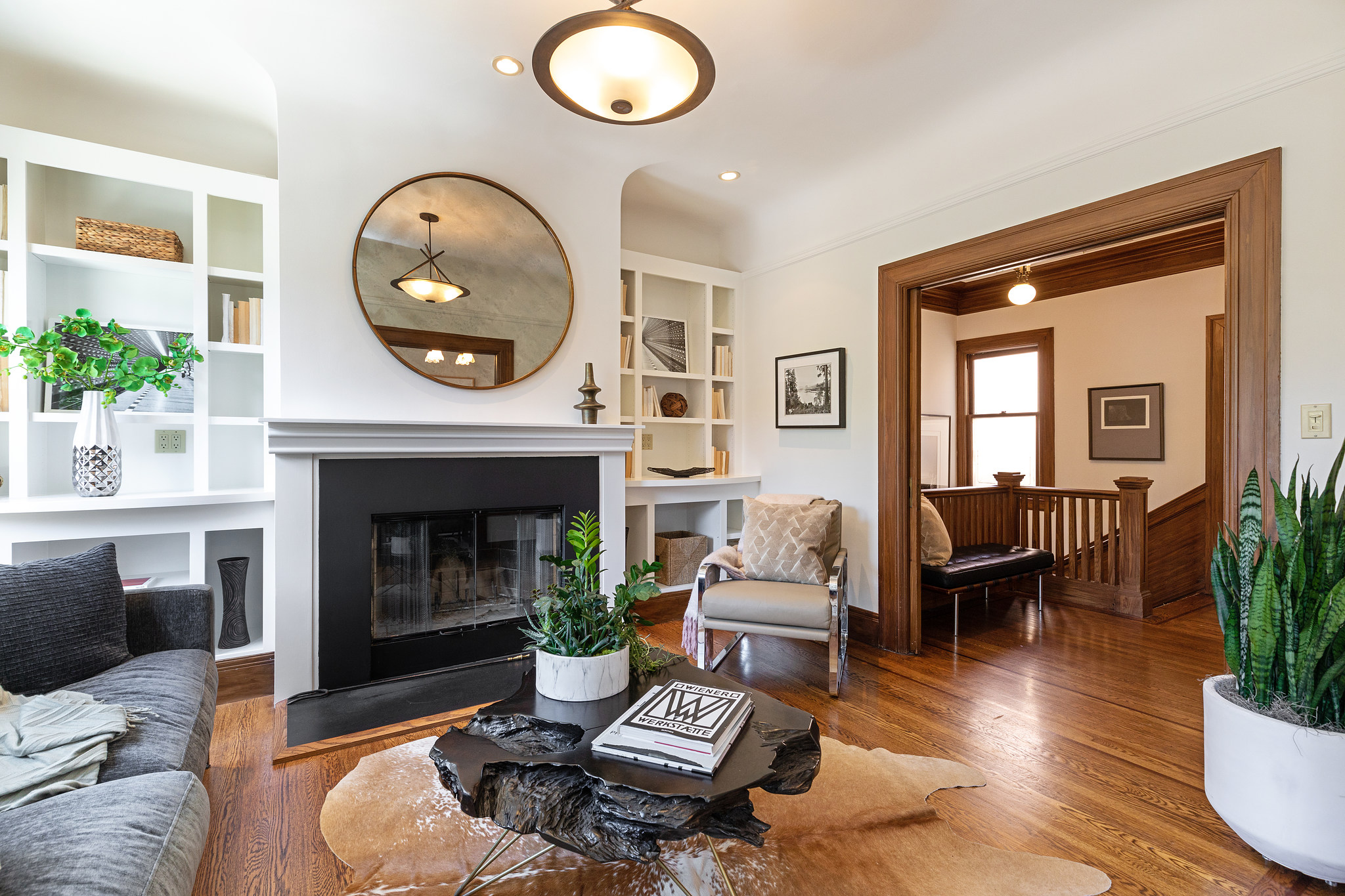 38-parnassus-avenue.47355.p2k.011.web View of the living room at 38 Parnassus Avenue, featuring a fireplace from black facade and white mantle