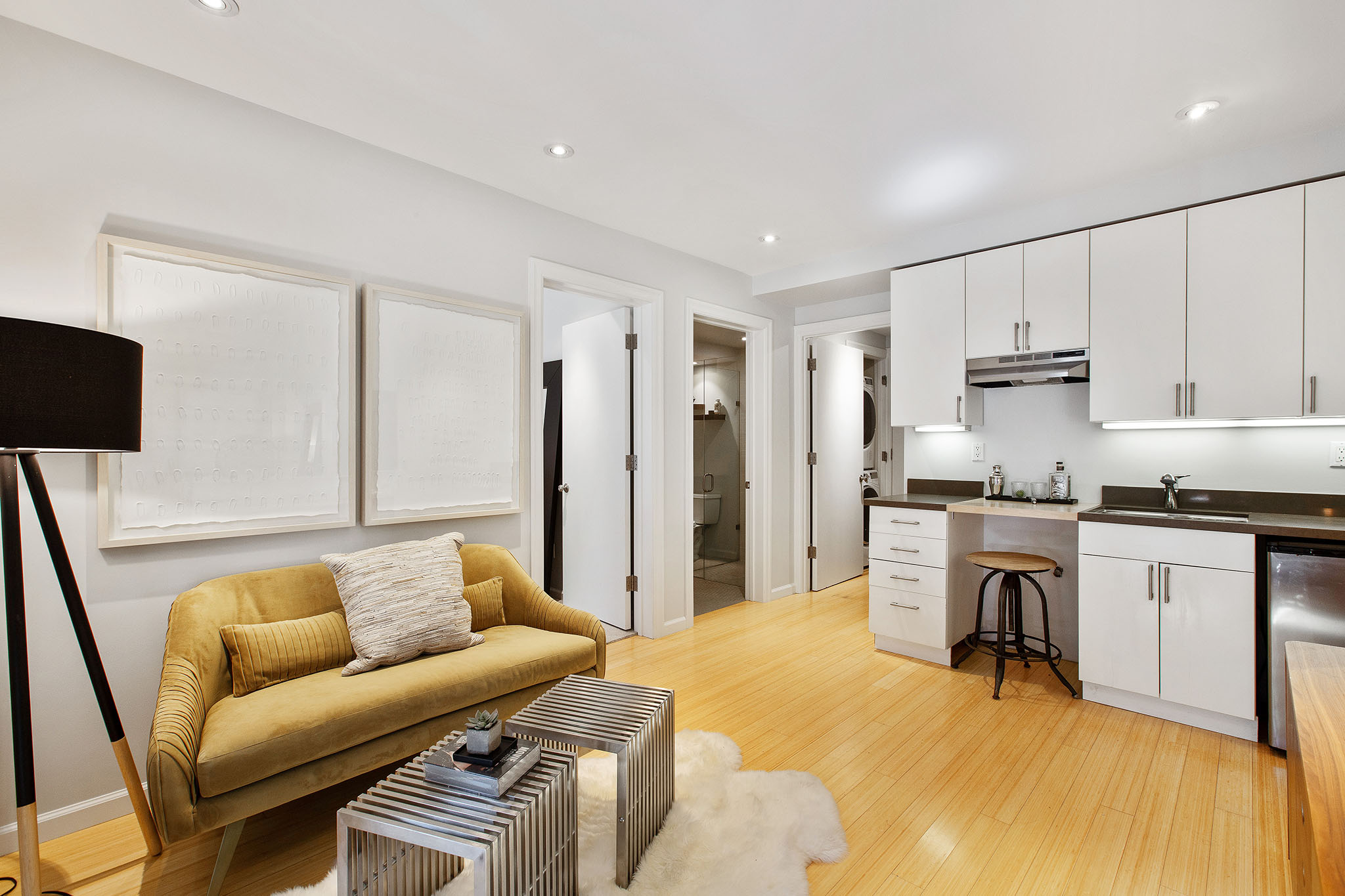 Looking over sitting room on lower from french doors. There is a small wet bar with small sink and mini fridge.