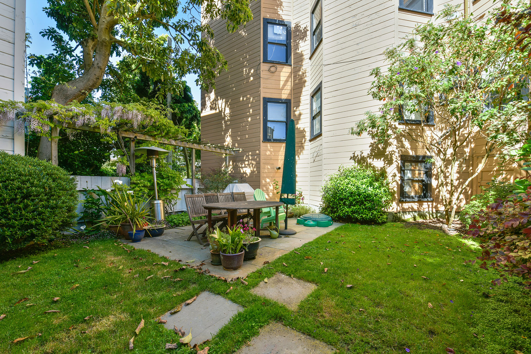View of the backyard, showing a grassy area and patio