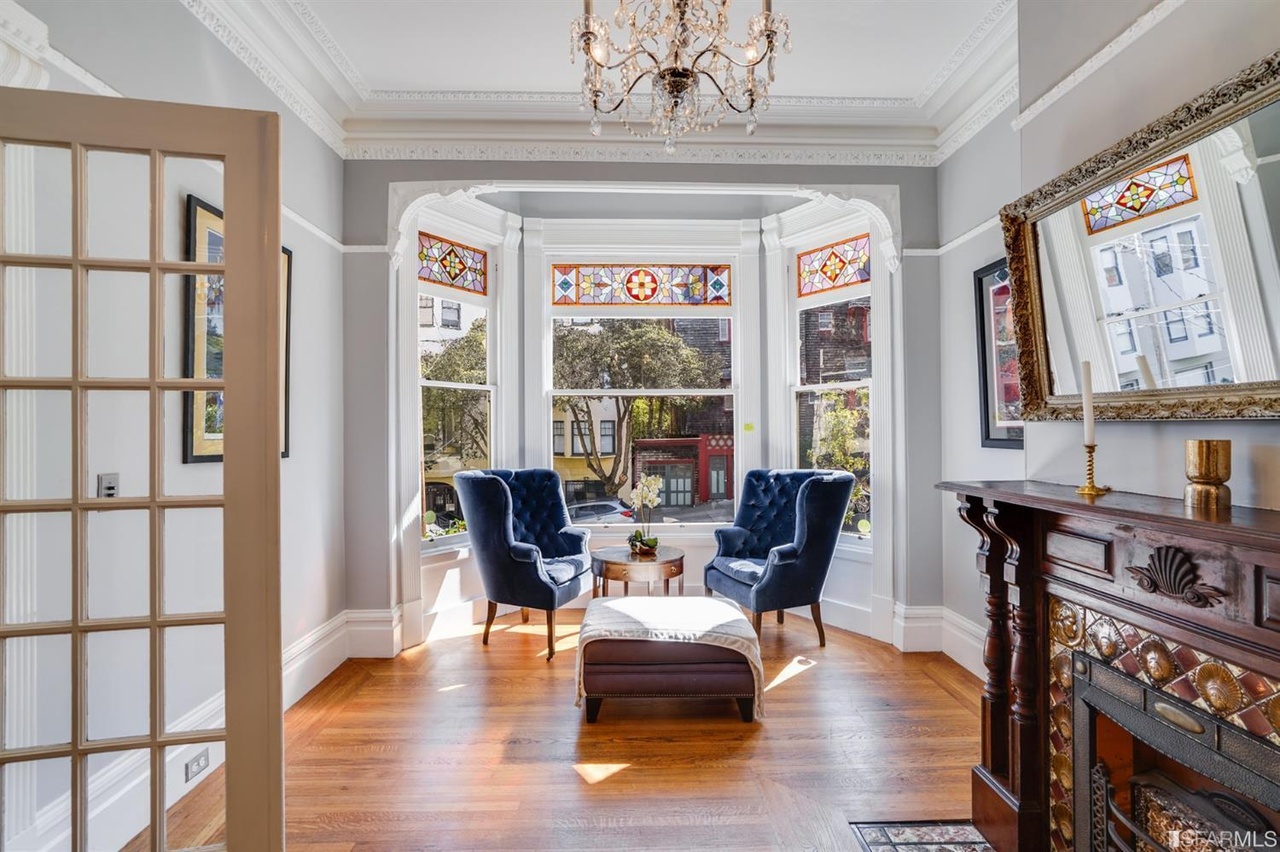 421594575100 View of a setting area, with bay windows and wood floors
