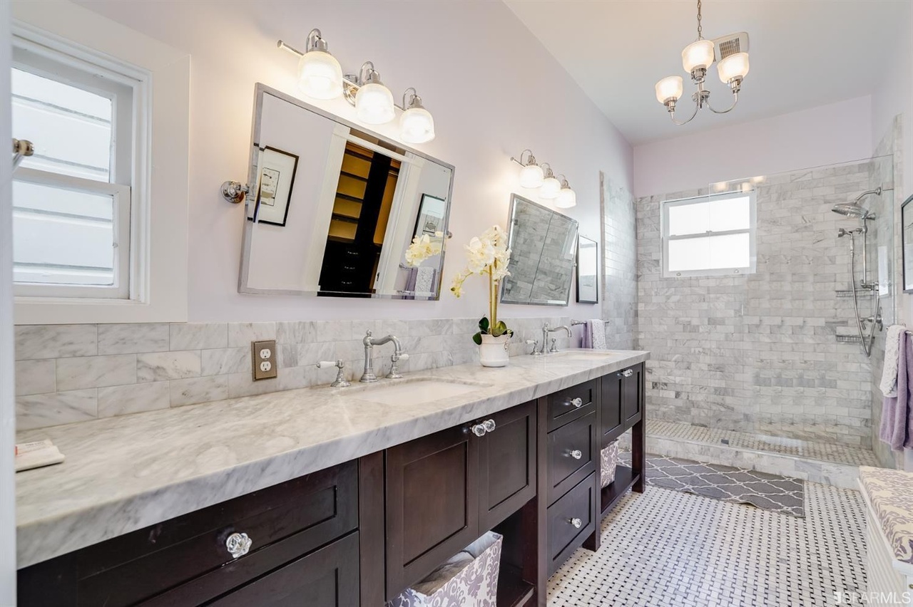 421594575261 View of a luxurious bathroom, showing marble counters and tiled floors