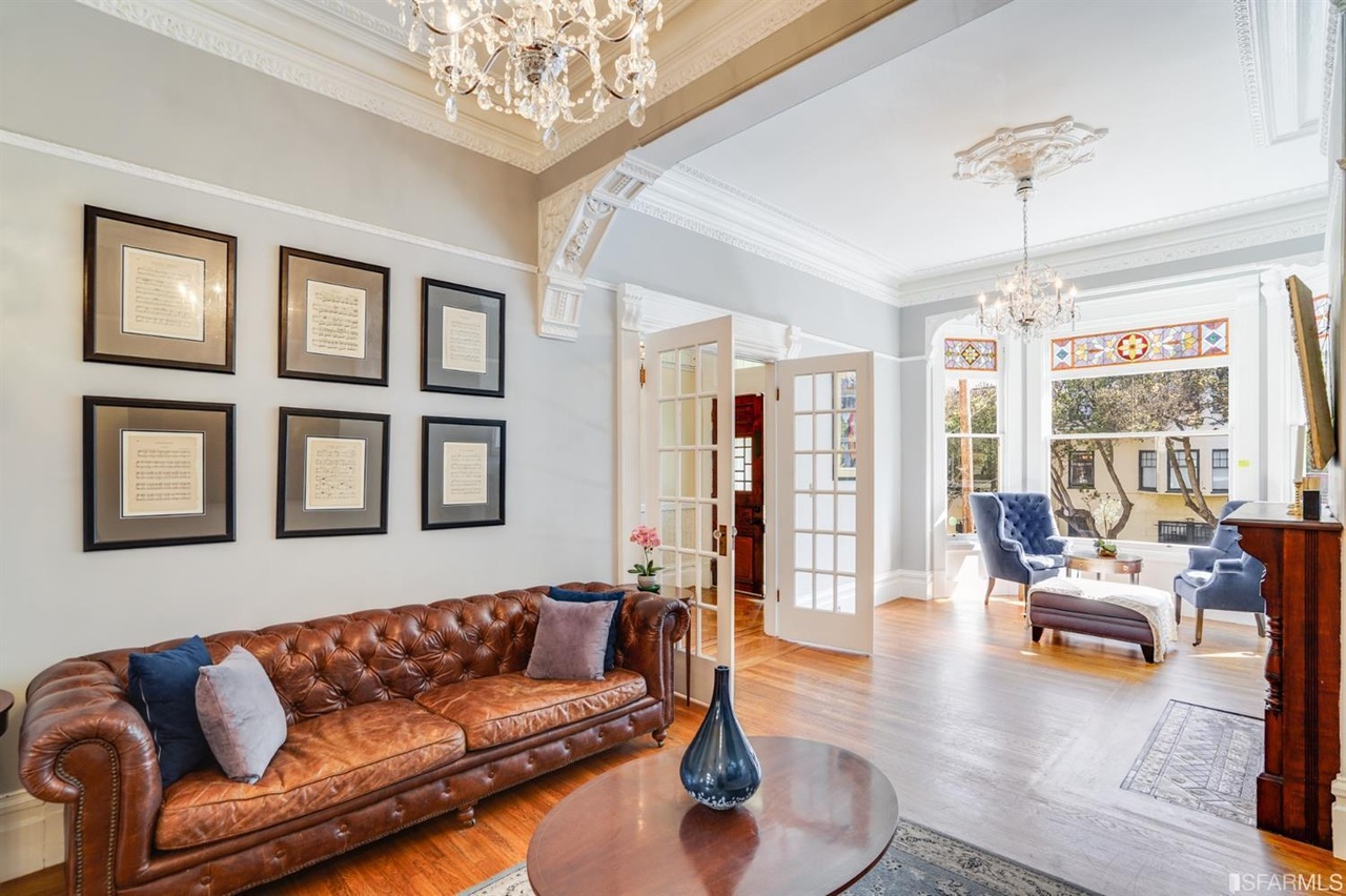 42159457590 View of the living room with chandeliers and crown moulding