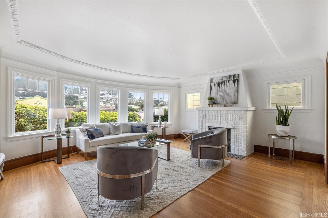 421601381180 Living room at 78 Wawona Street, featuring white walls, white fireplace, and large windows