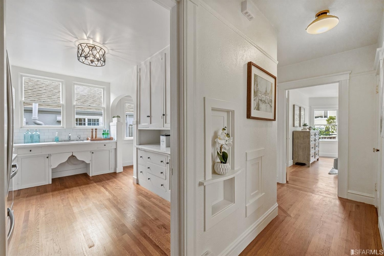 421601381400 View from the hall, showing a glimpse of the kitchen to the left and access to the living area on the right