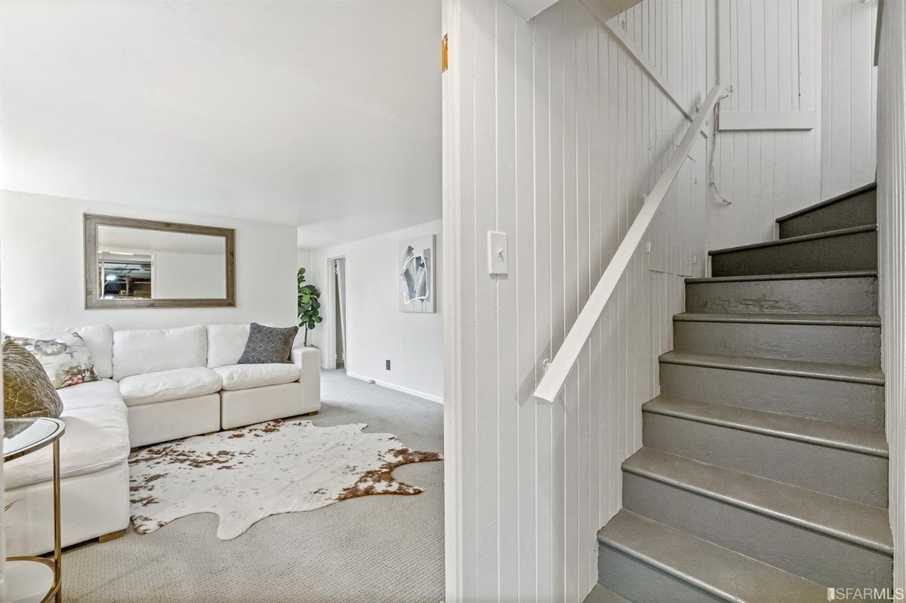 421601381620 View of the lower living area and stairs leading up to the main level