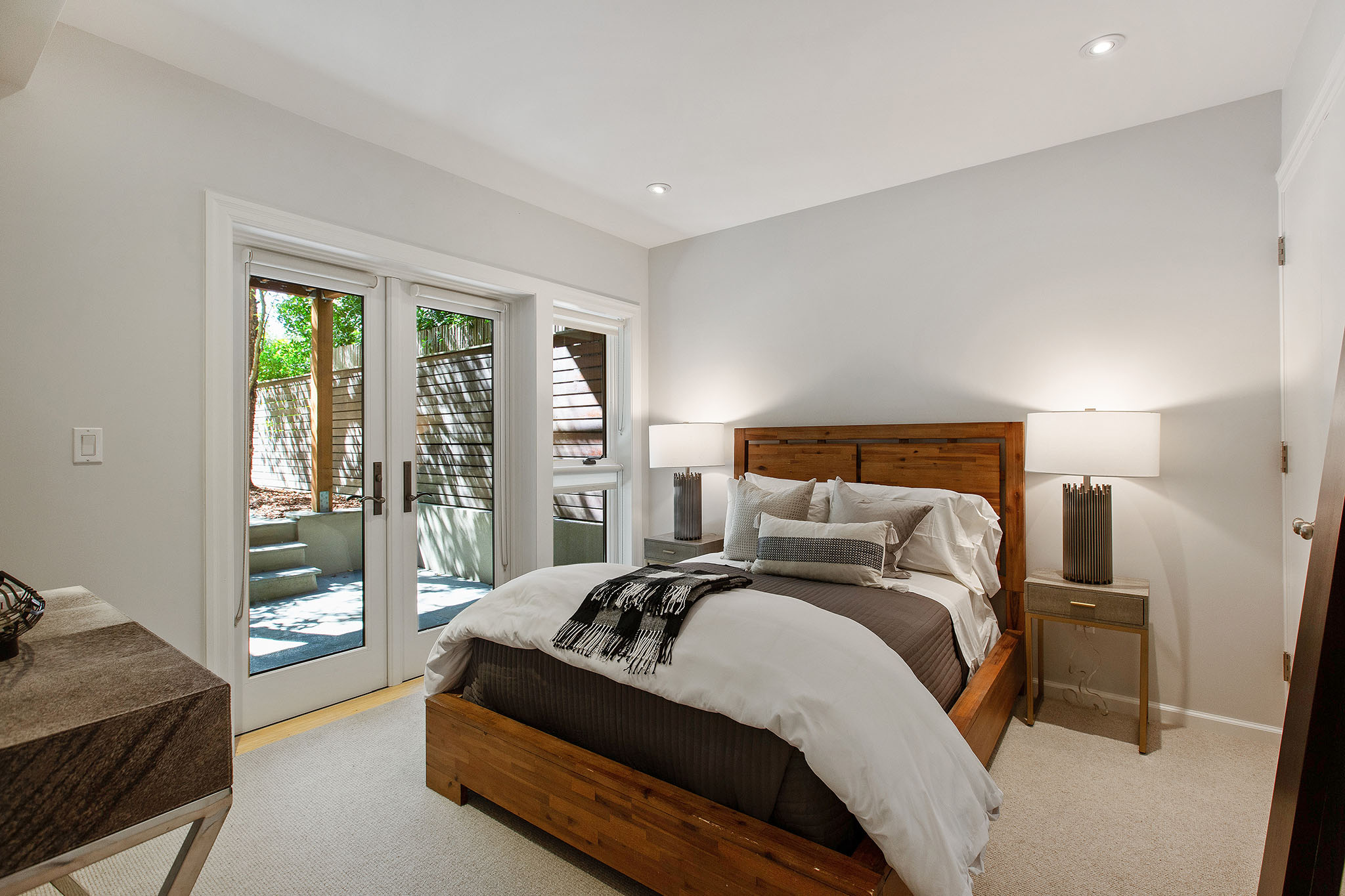 View of a third bedroom, with large French exterior doors