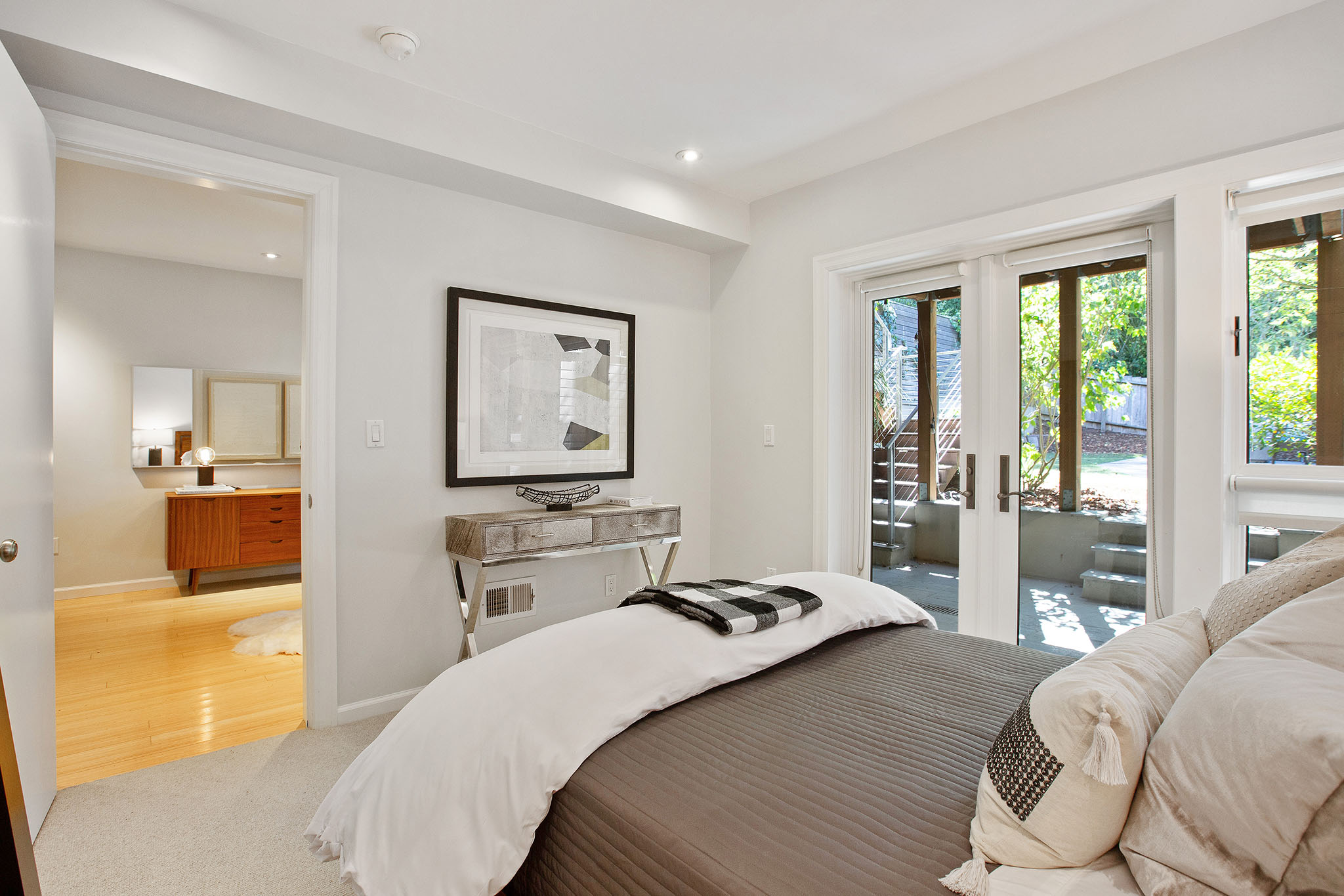 The floors in the third bedroom are wood but there is large grey area rug.