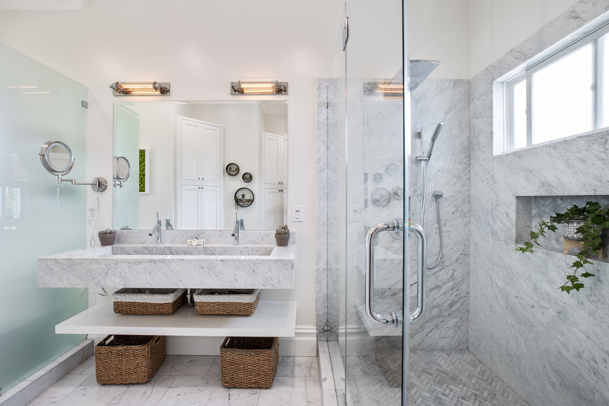 View of a luxurious bathroom with marble and a glass shower