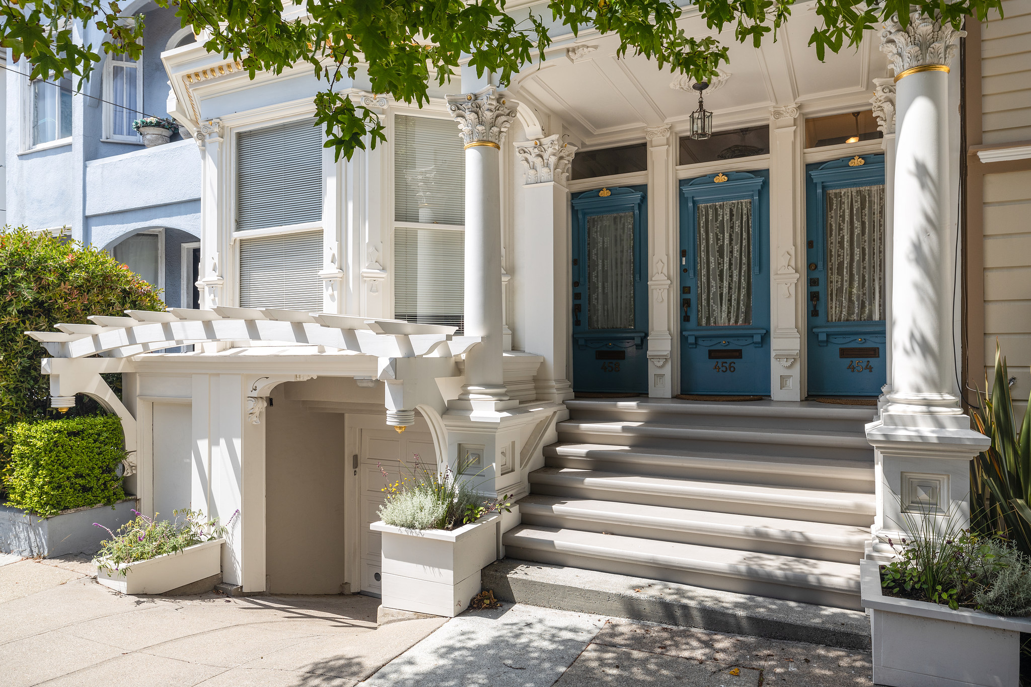 Front entry to 454 Frederick Street, showing three blue doors