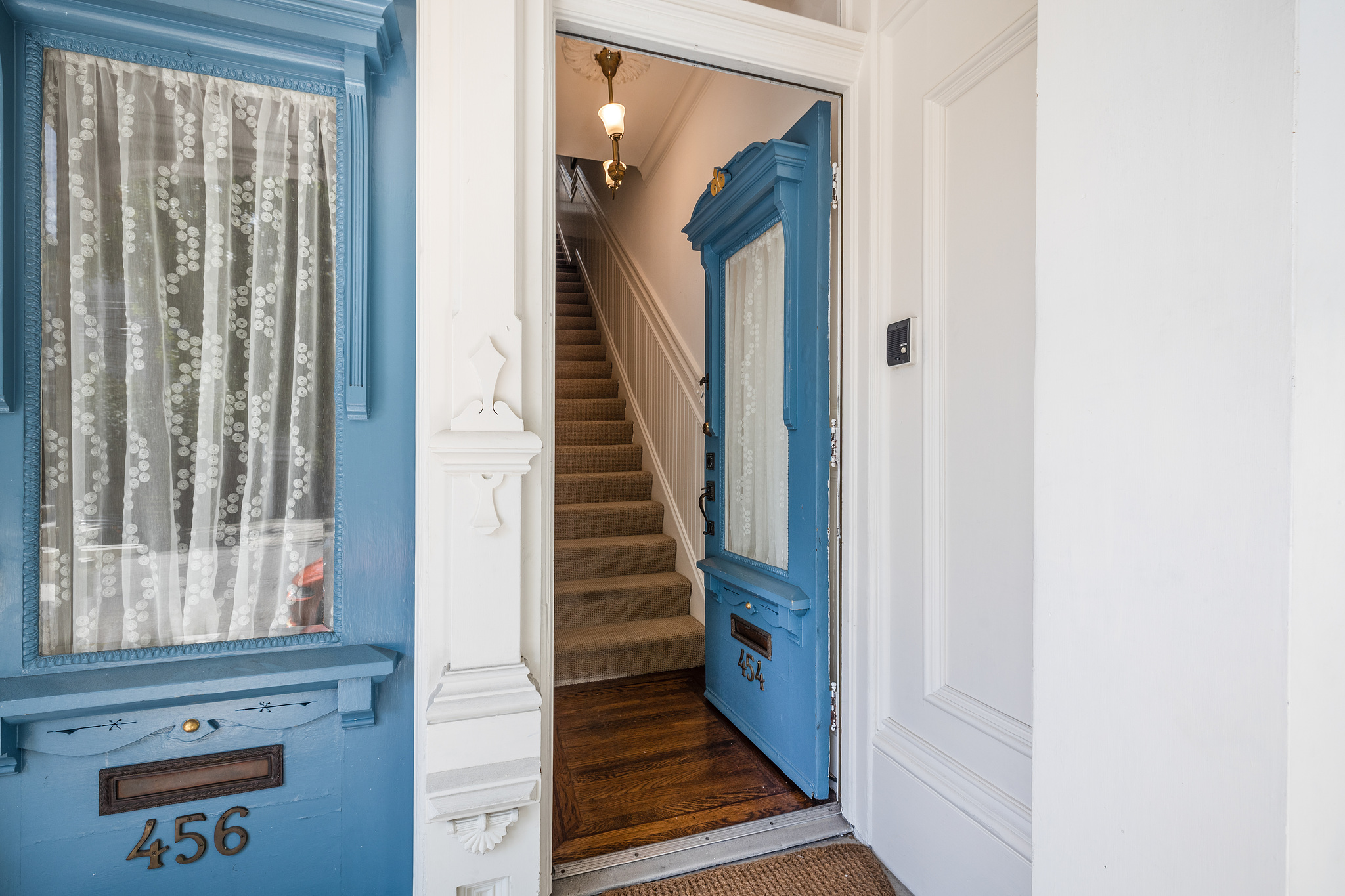 Front door to 454 Frederick Street stands open, showing stairs leading upwards