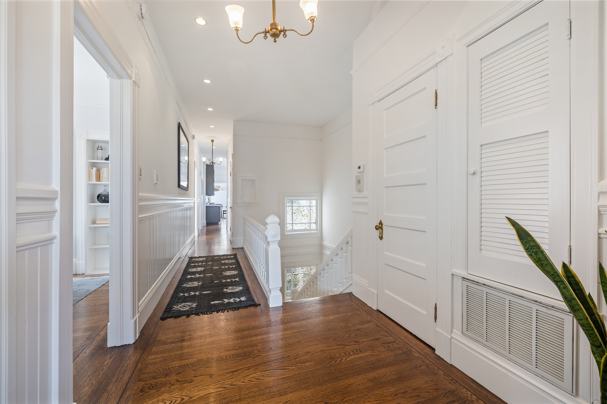 Hallway with wood floors and white walls