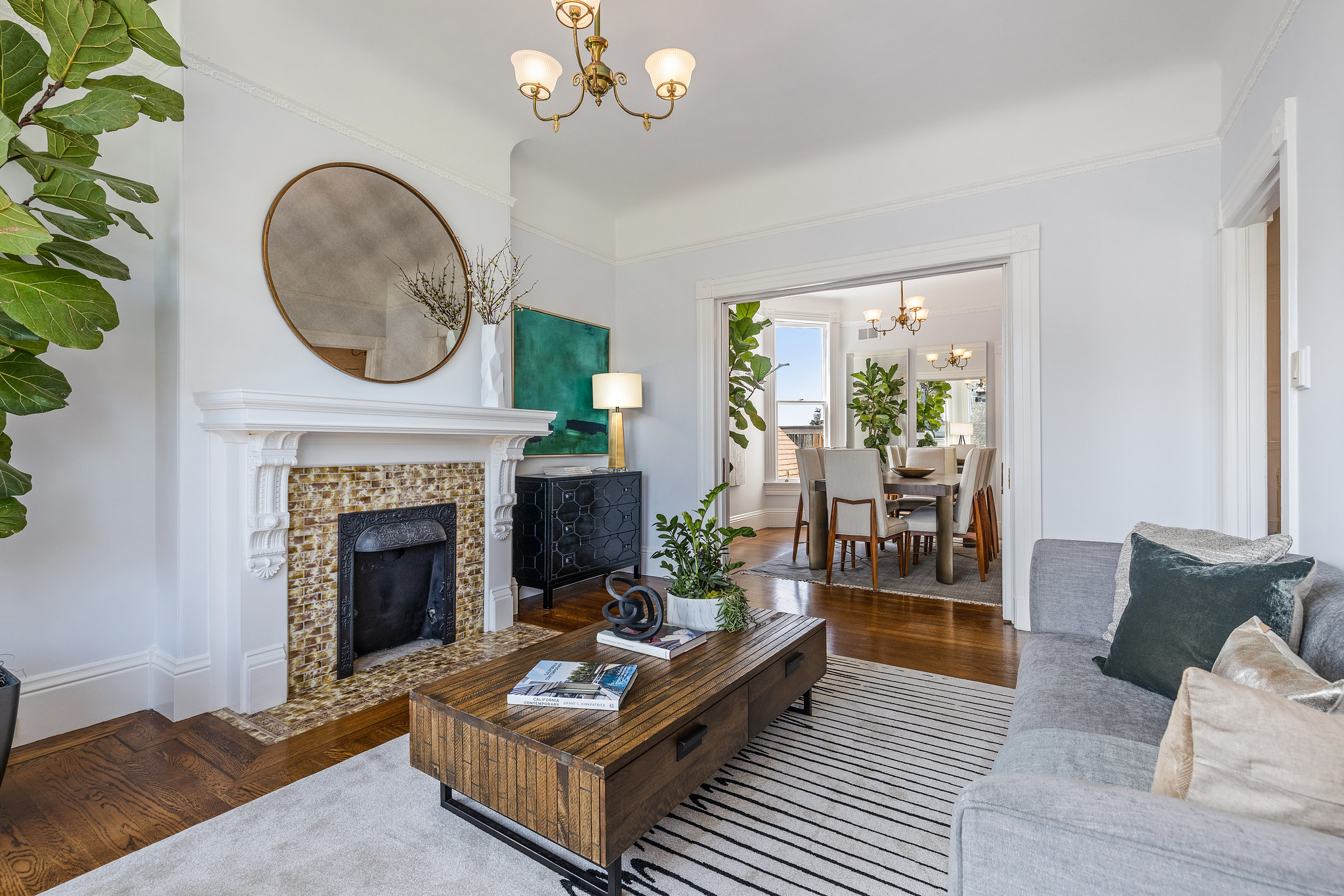 Living room at 454 Frederick Street, showing a fireplace and view into the dining area
