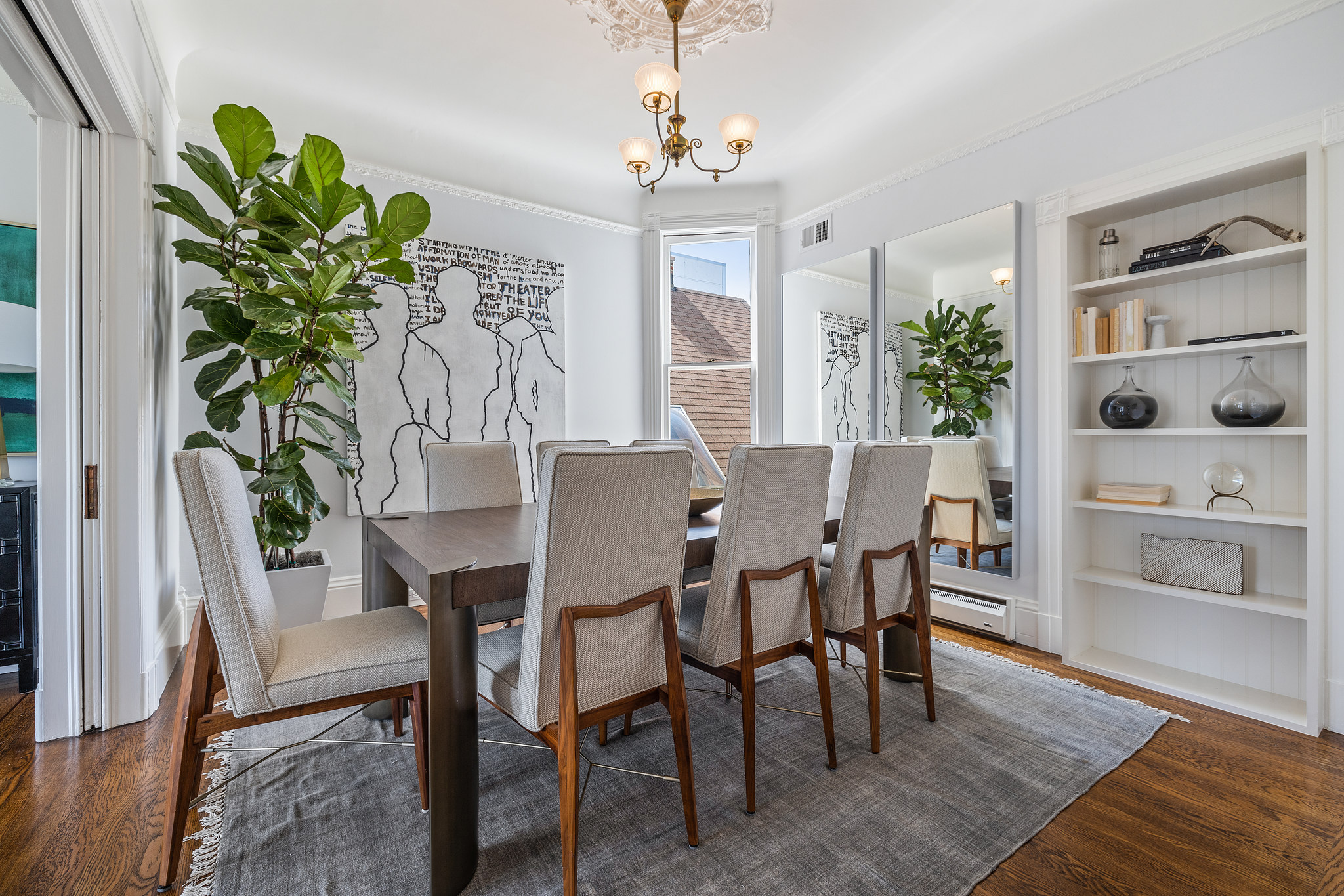 Side-view of the formal dining room, featuring wood floors