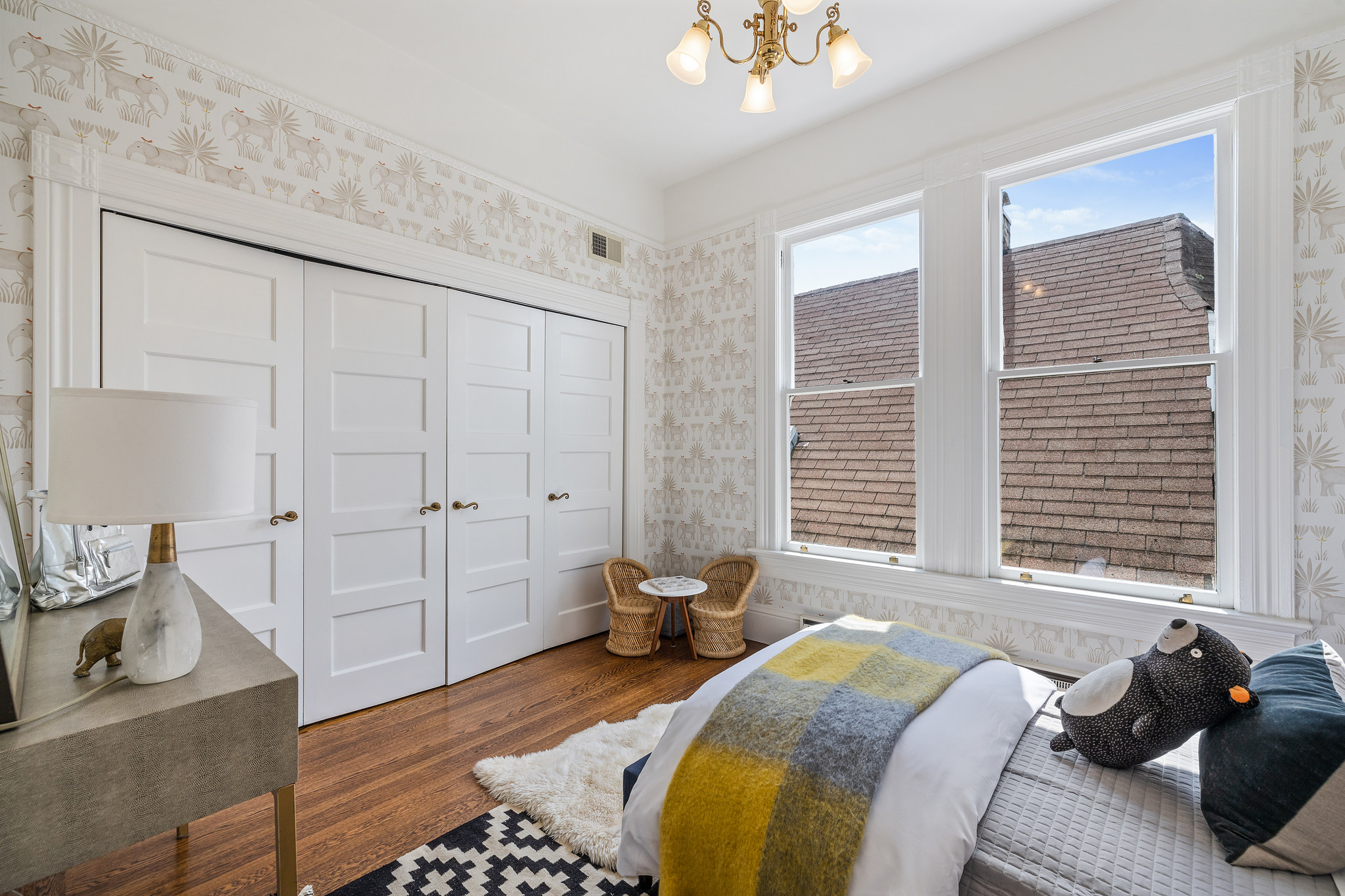 View of a bedroom with double windows and two closets