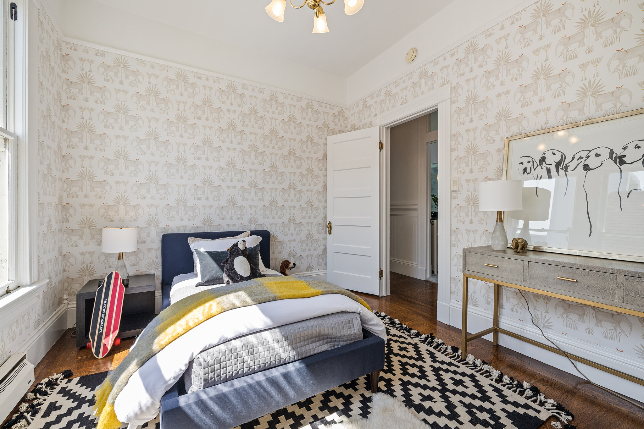 View of the bedroom with tan and white wall-paper