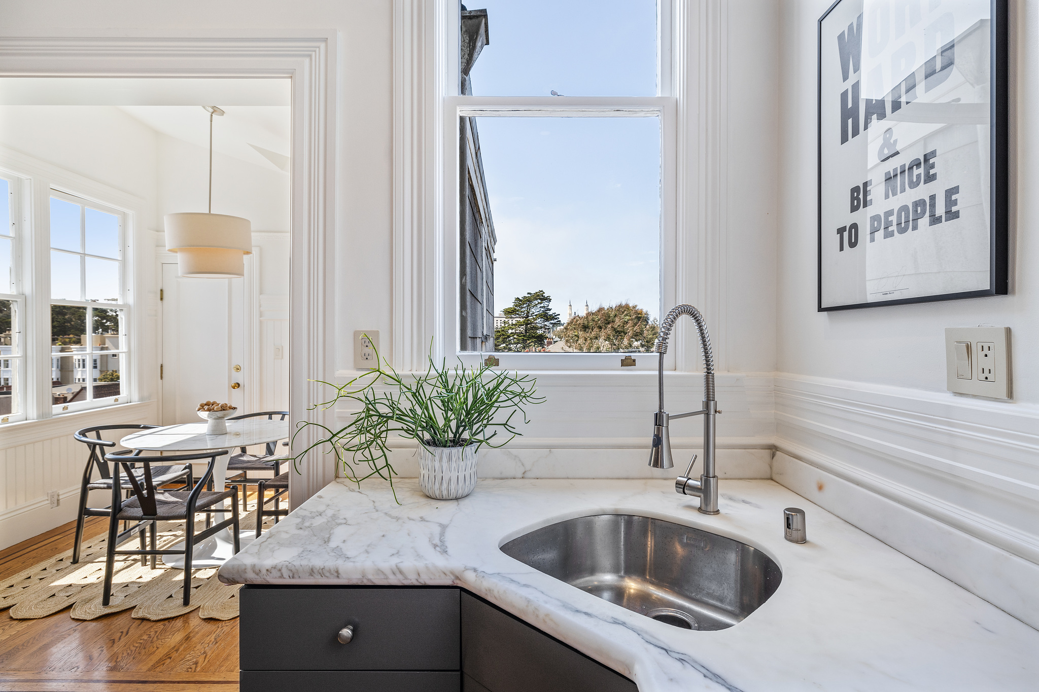 Close-up of the kitchen, featuring the sink with window