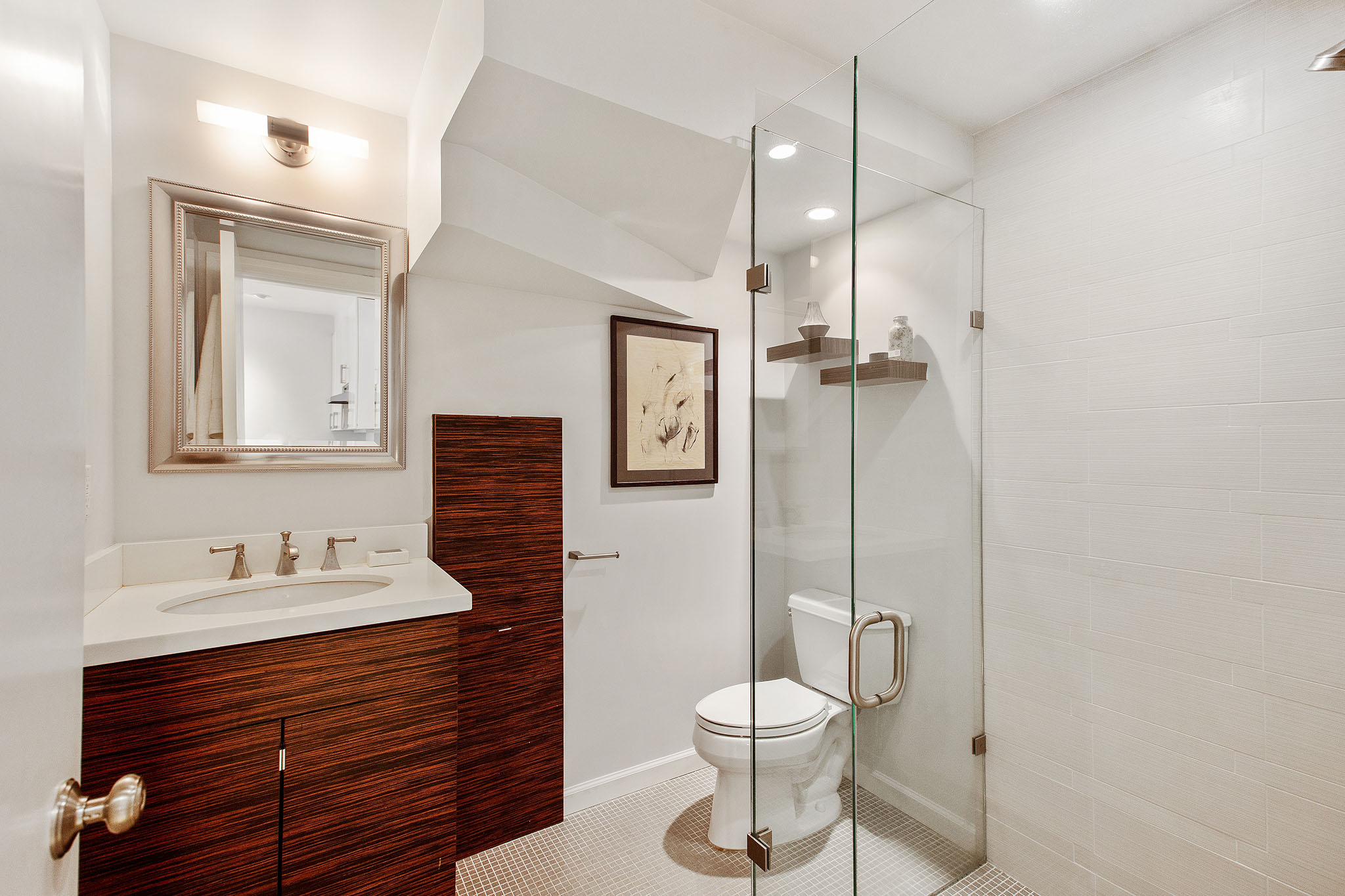 The second bathroom has stand alone shower, toilet and one sink vanity.