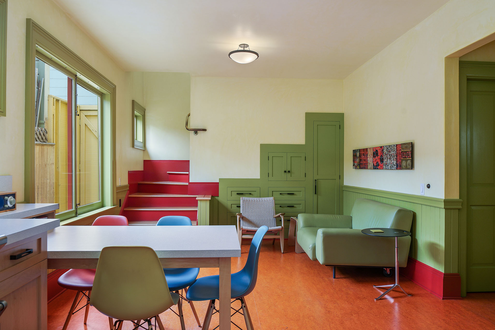View from the kitchen into an adjoining seating area, featuring unique built-in cabinets