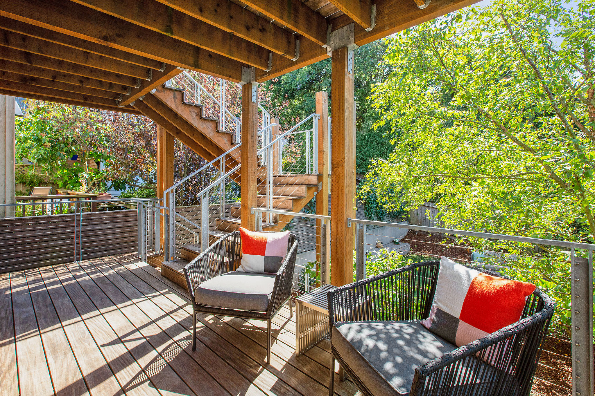 Deck area. There is a sitting area with chair and love seat.