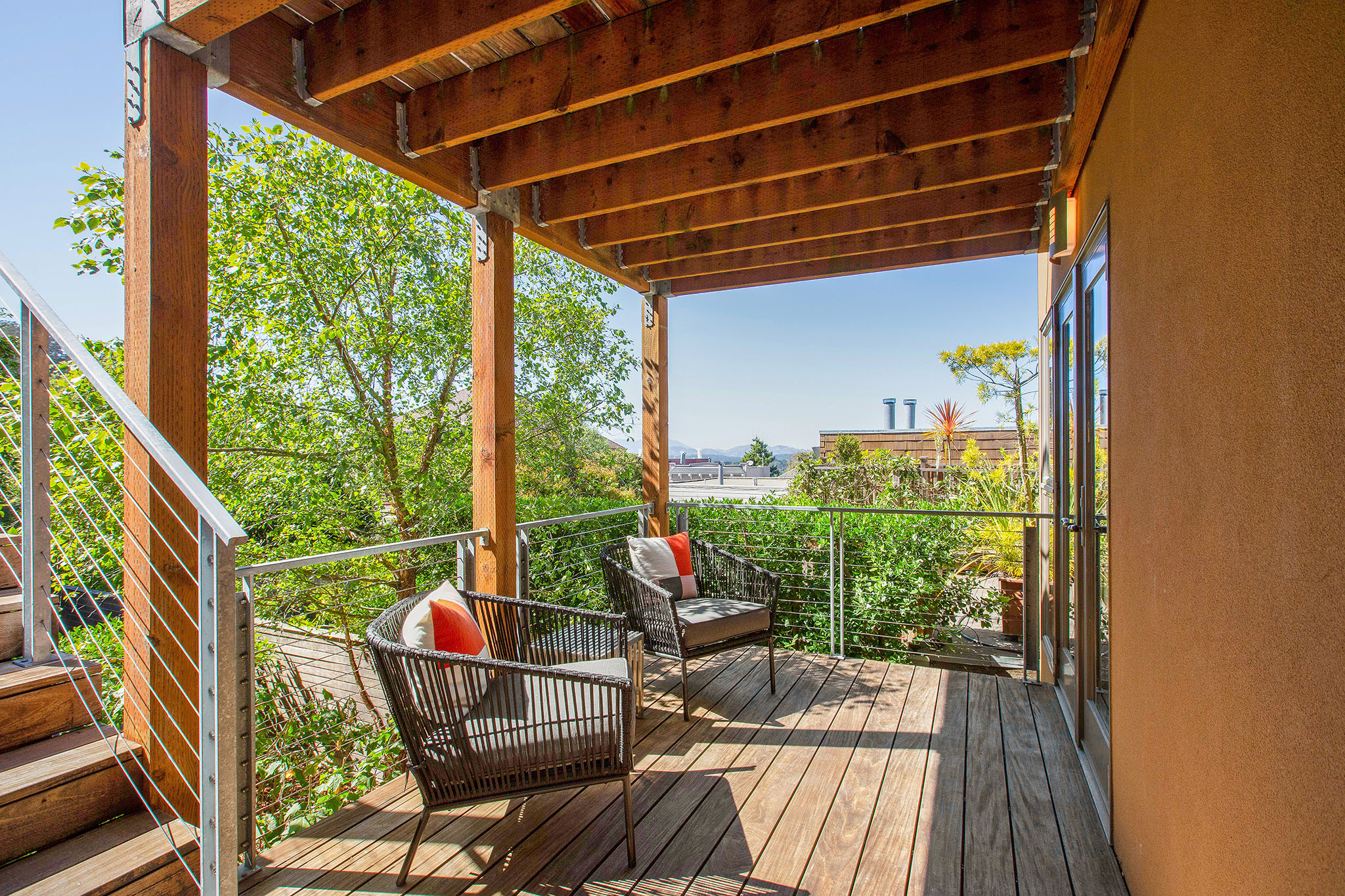 Looking over deck from side corner. There is a lot of greenery.