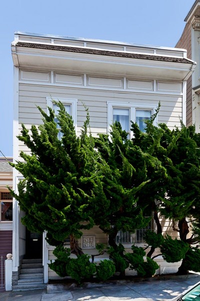 Front exterior of 514-516 Shrader Street, showing a home with tan facade