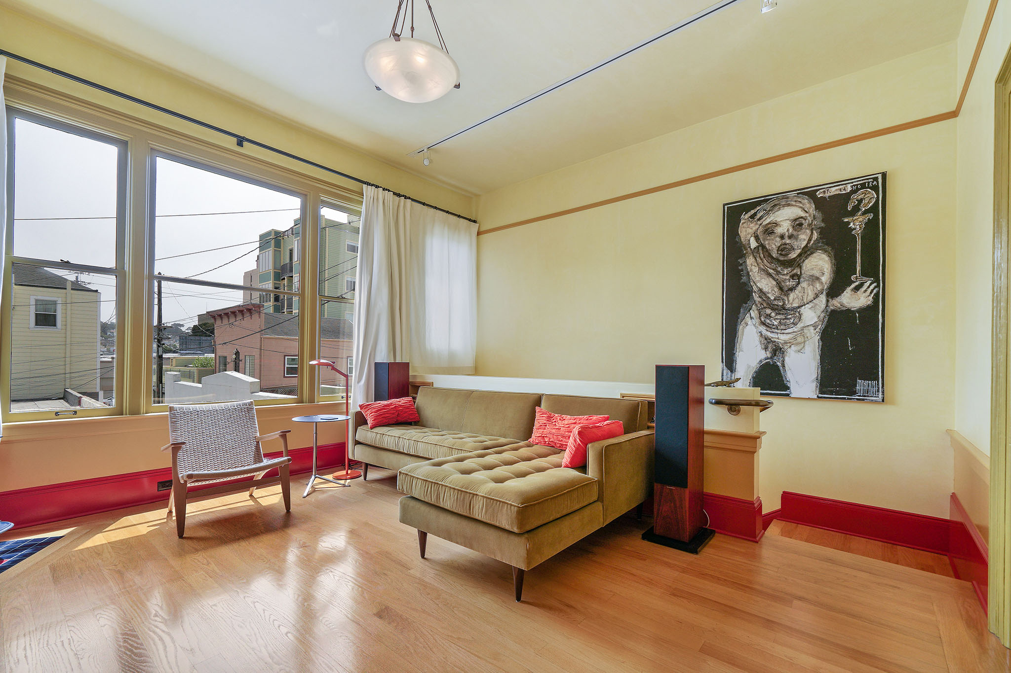 Living room with wood floors and large windows