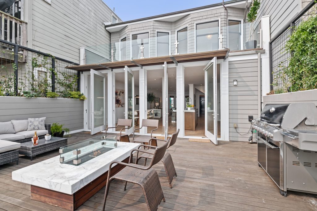 Upper patio at 55 Buena Vista Terrace, showing three sets of glass doors leading into the living area