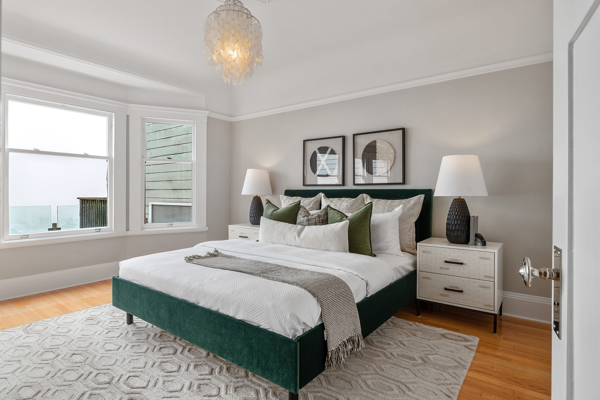 Bedroom with windows and wood floors