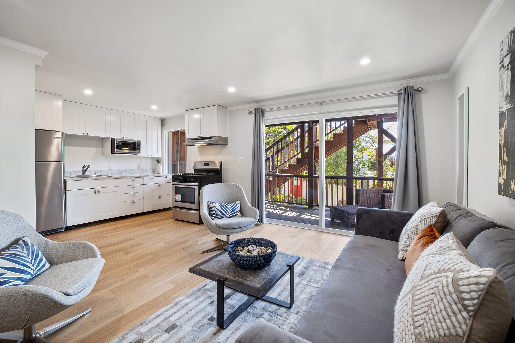View of the lower living area, featuring glass doors leading to the deck