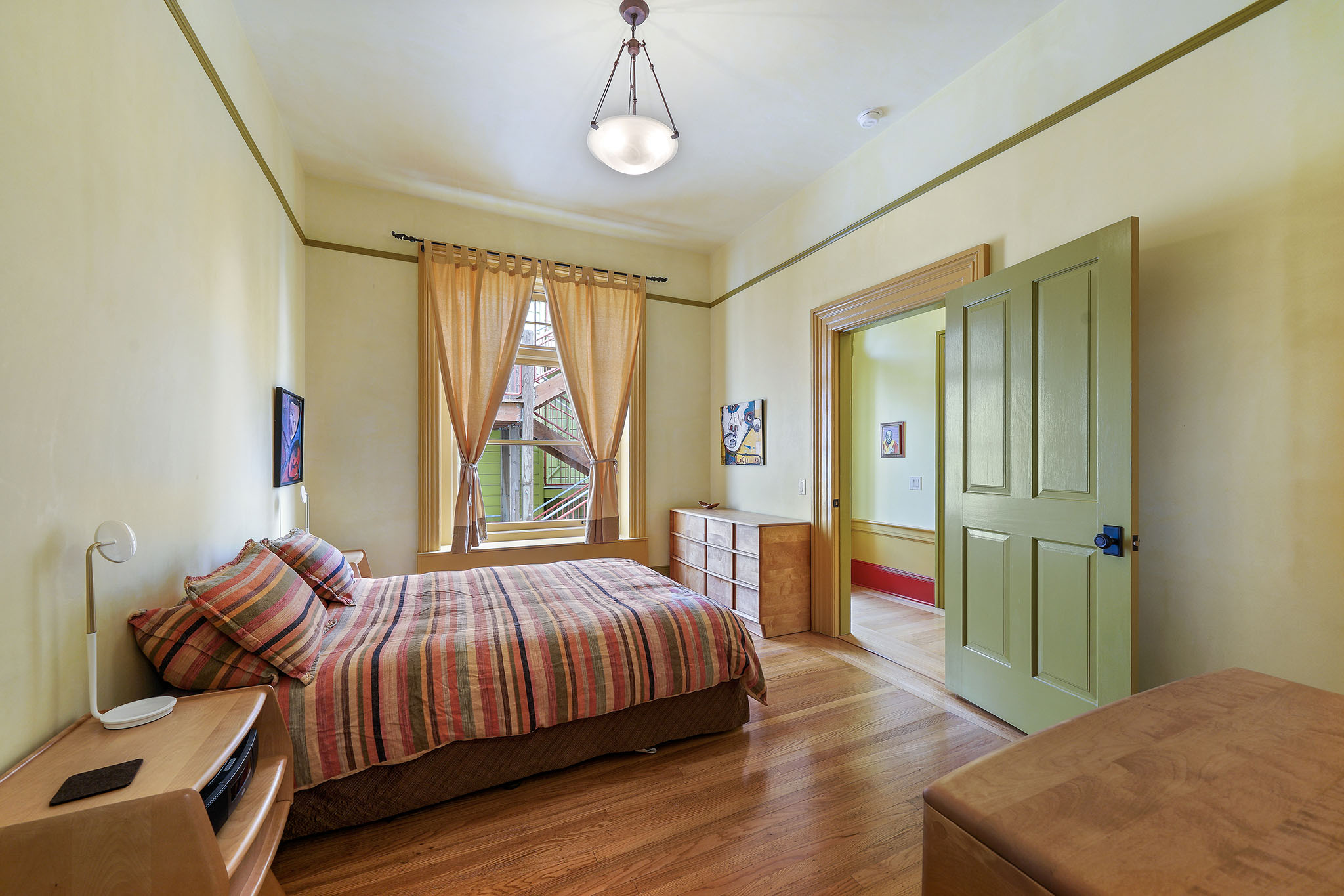 Bedroom with large windows and wide wood trim