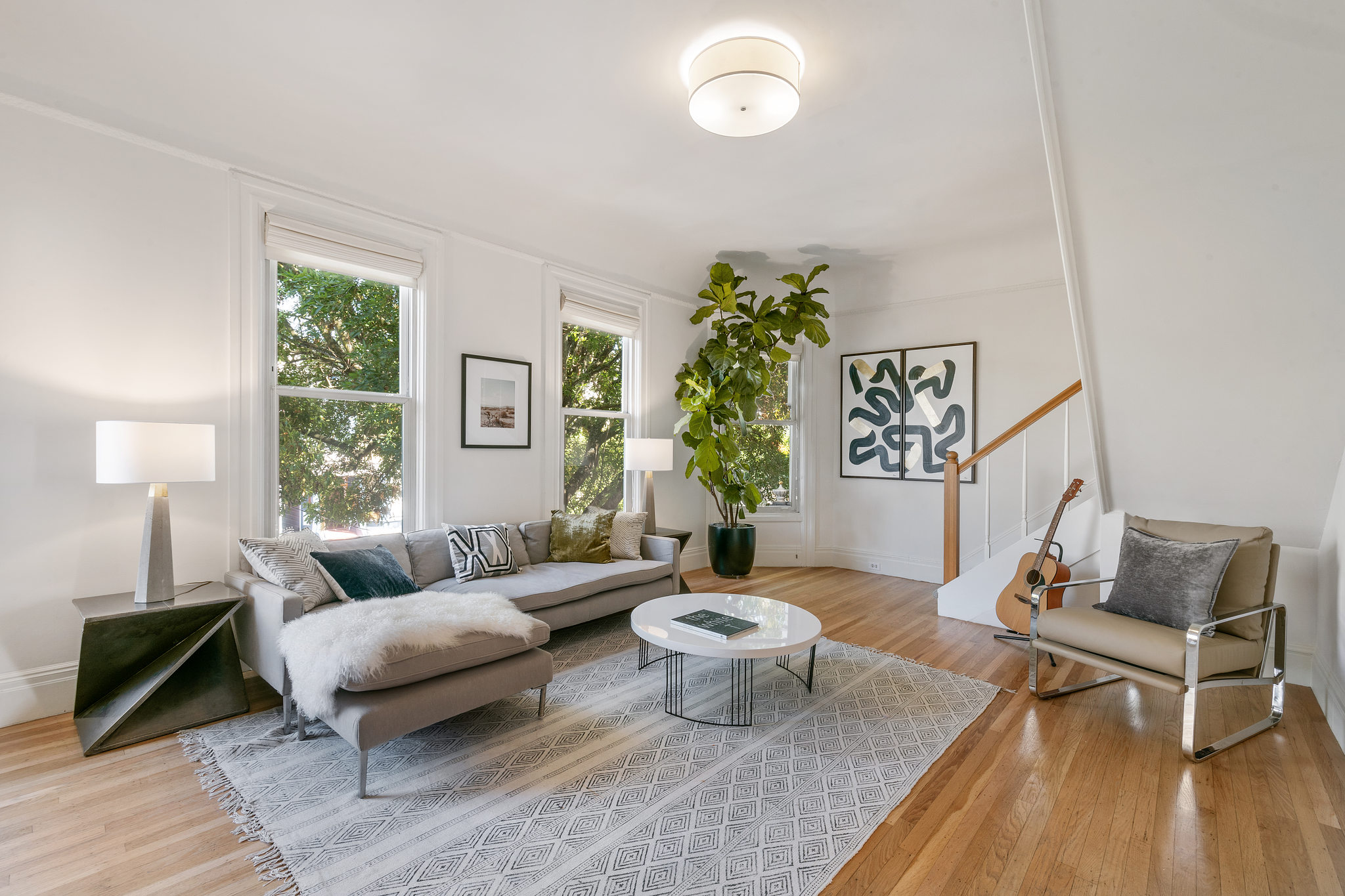 717-cole-street.37789.p3k.30.web View of a living room with two large windows and stairs leading up