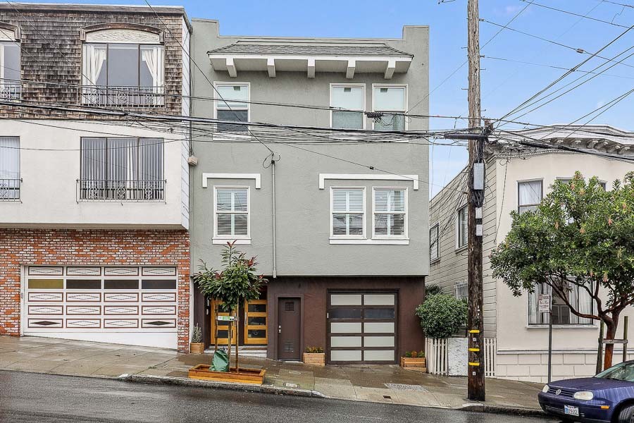 Front exterior view of 719 18th Avenue, featuring a home with grey/green facade