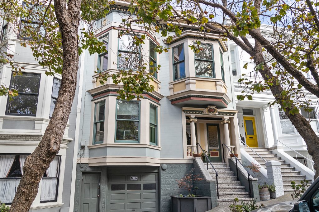 Exterior view of 726 Clayton Street, featuring a light blue Victorian home