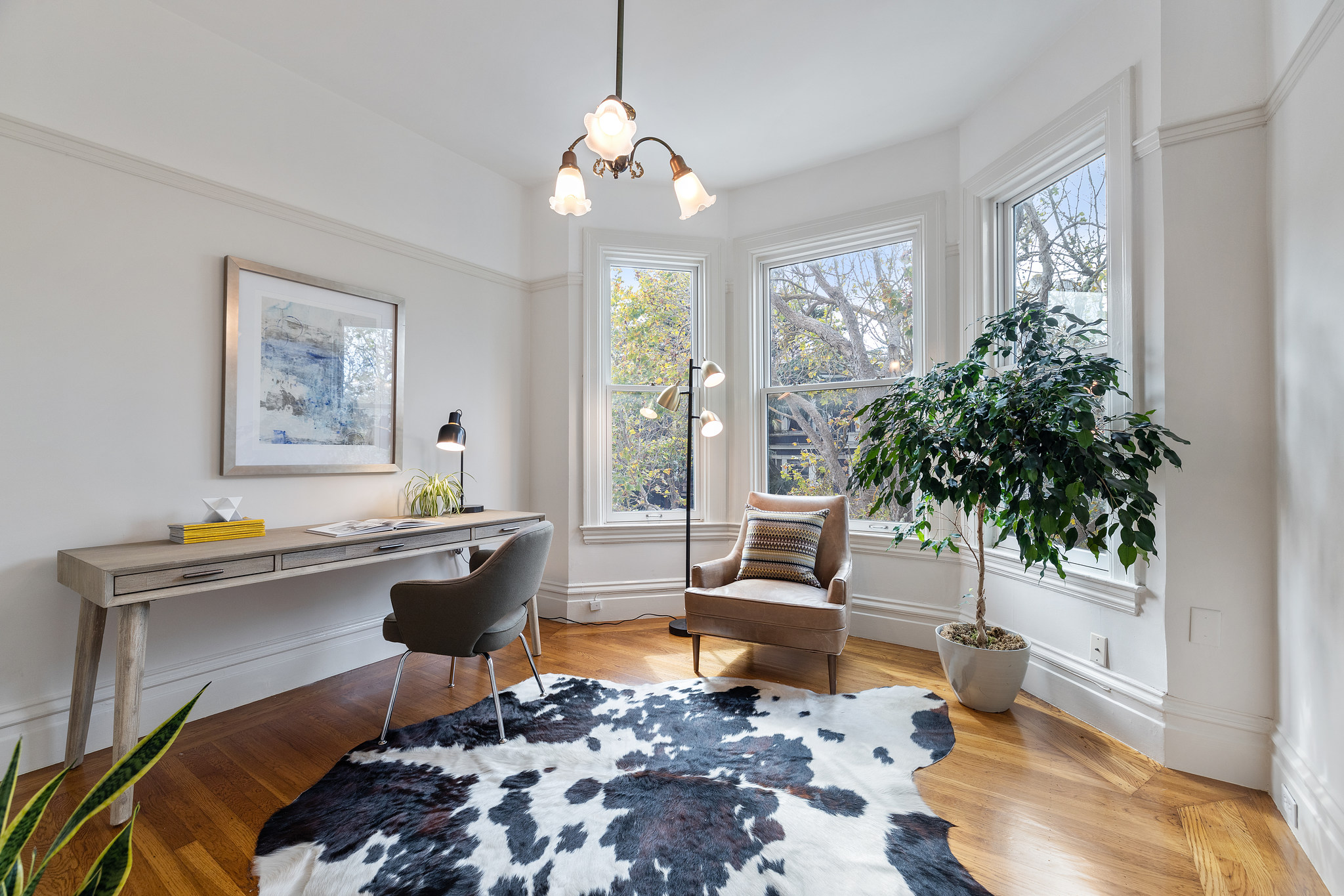 Living area featuring wood floors and large windows