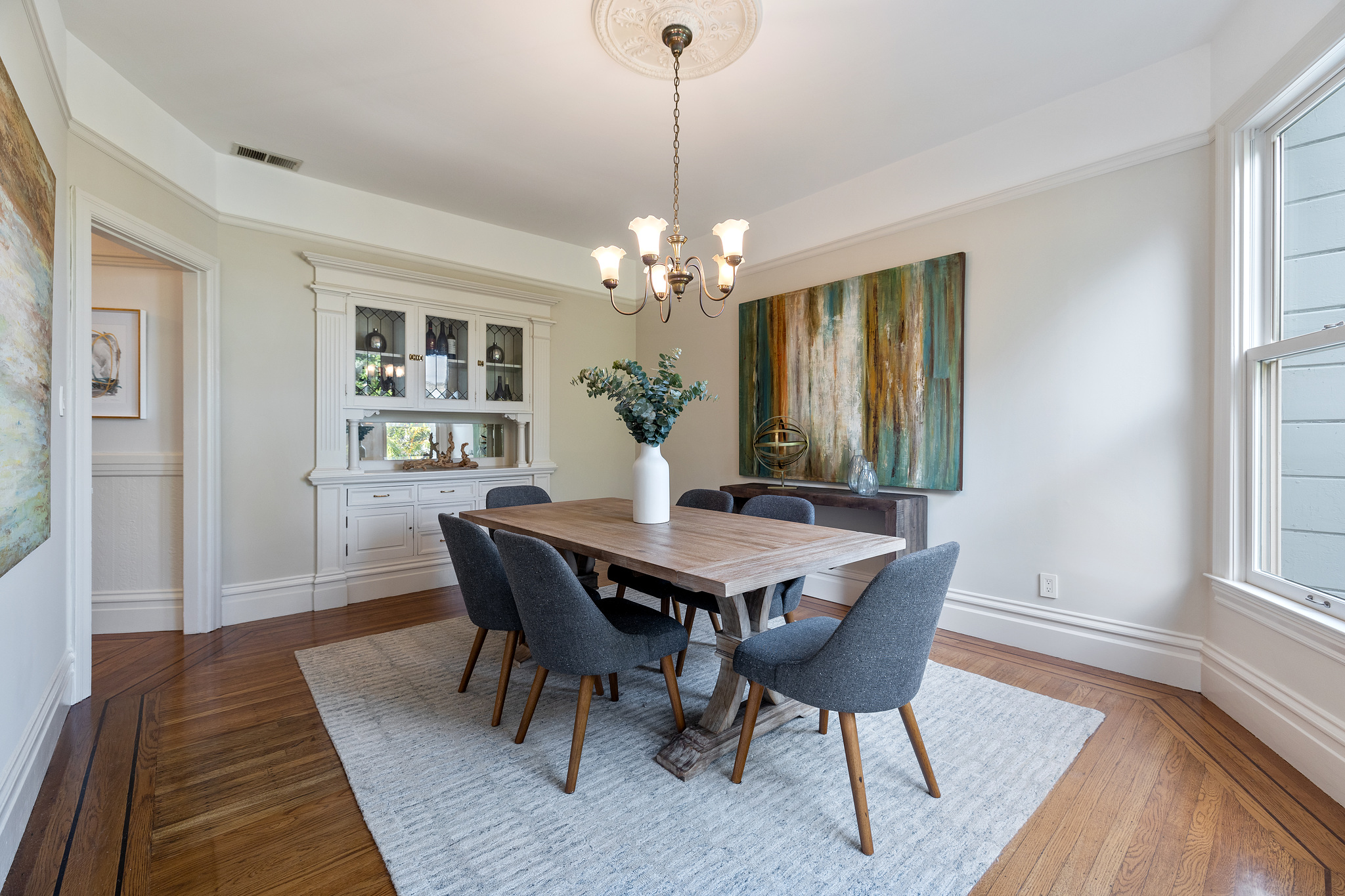 View of the dining room from the window, looking towards a large built-in cabinet
