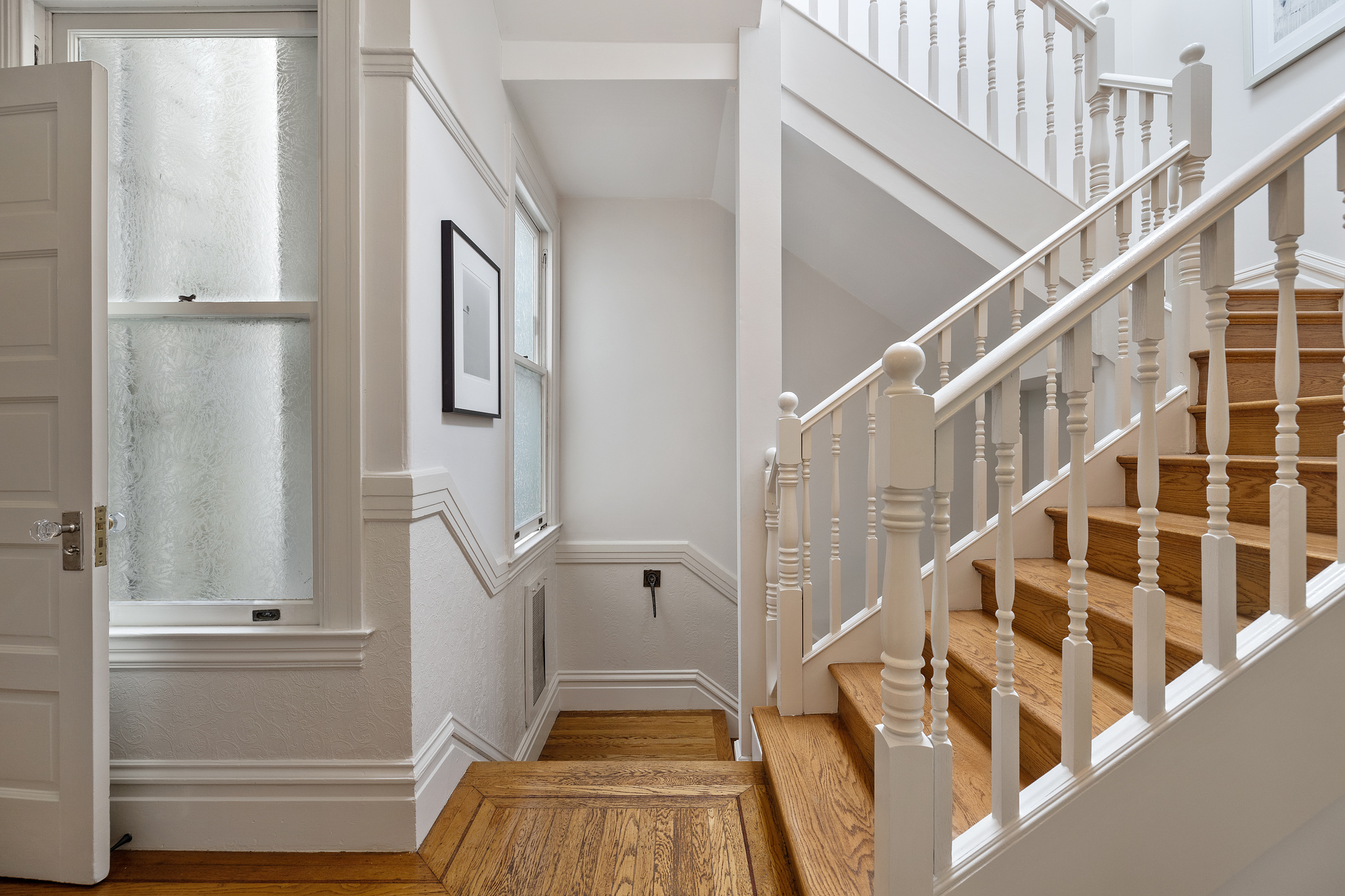 Wooden stairway with white railing