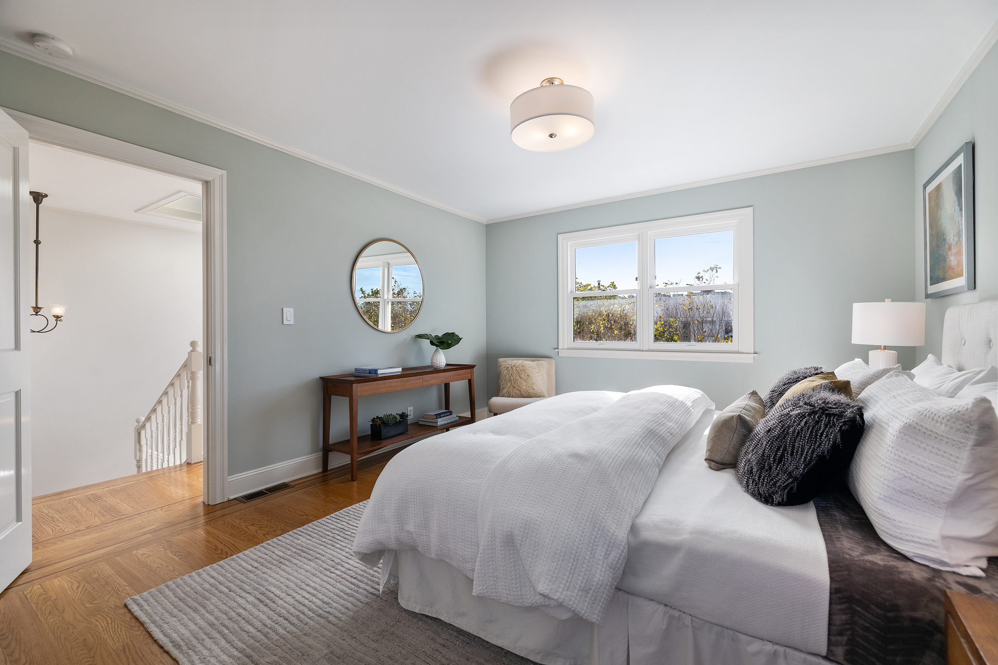View of a large top-floor bedroom with views of the city
