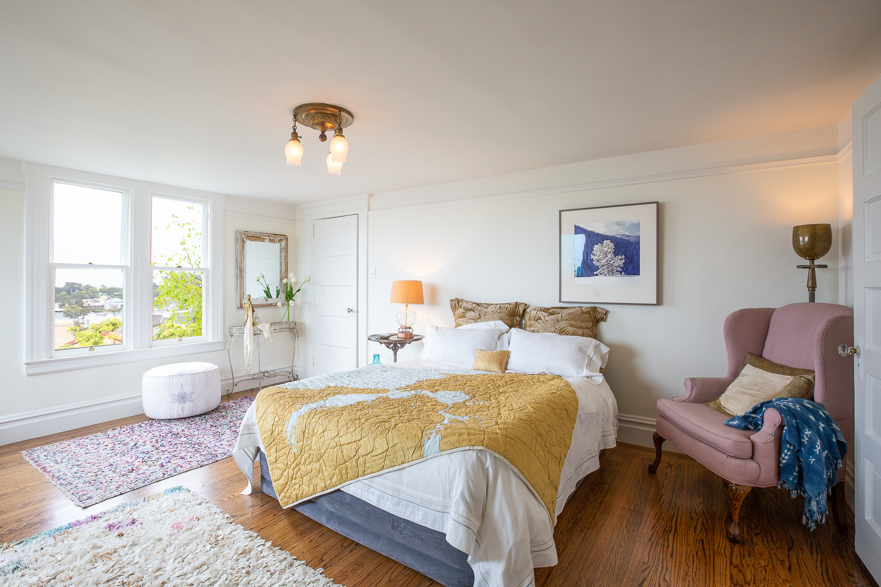 Bedroom with large windows and wood floor