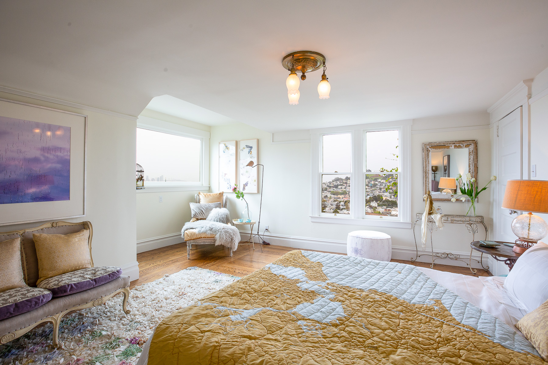 View of a large bedroom with lots of natural light