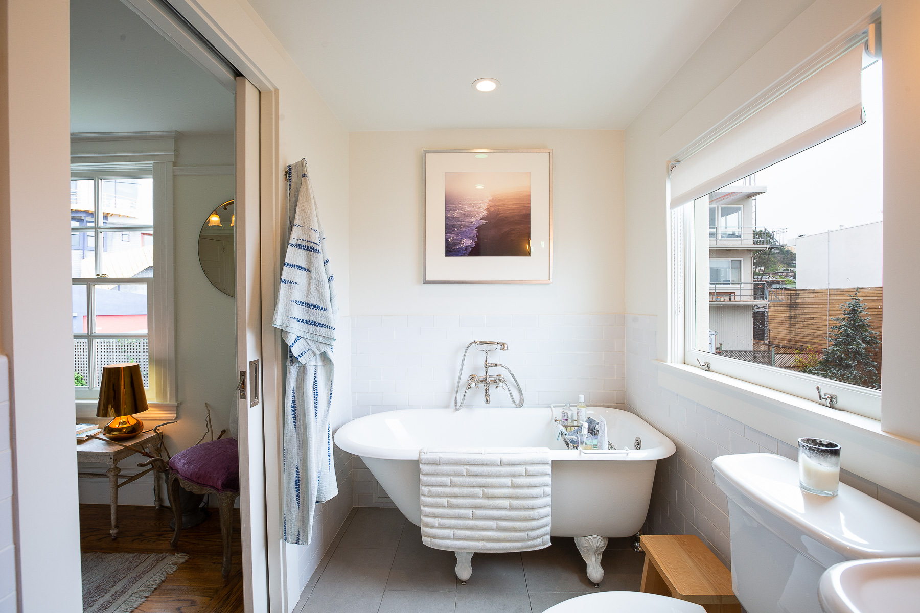View of a vintage free-standing bath positioned near a large window