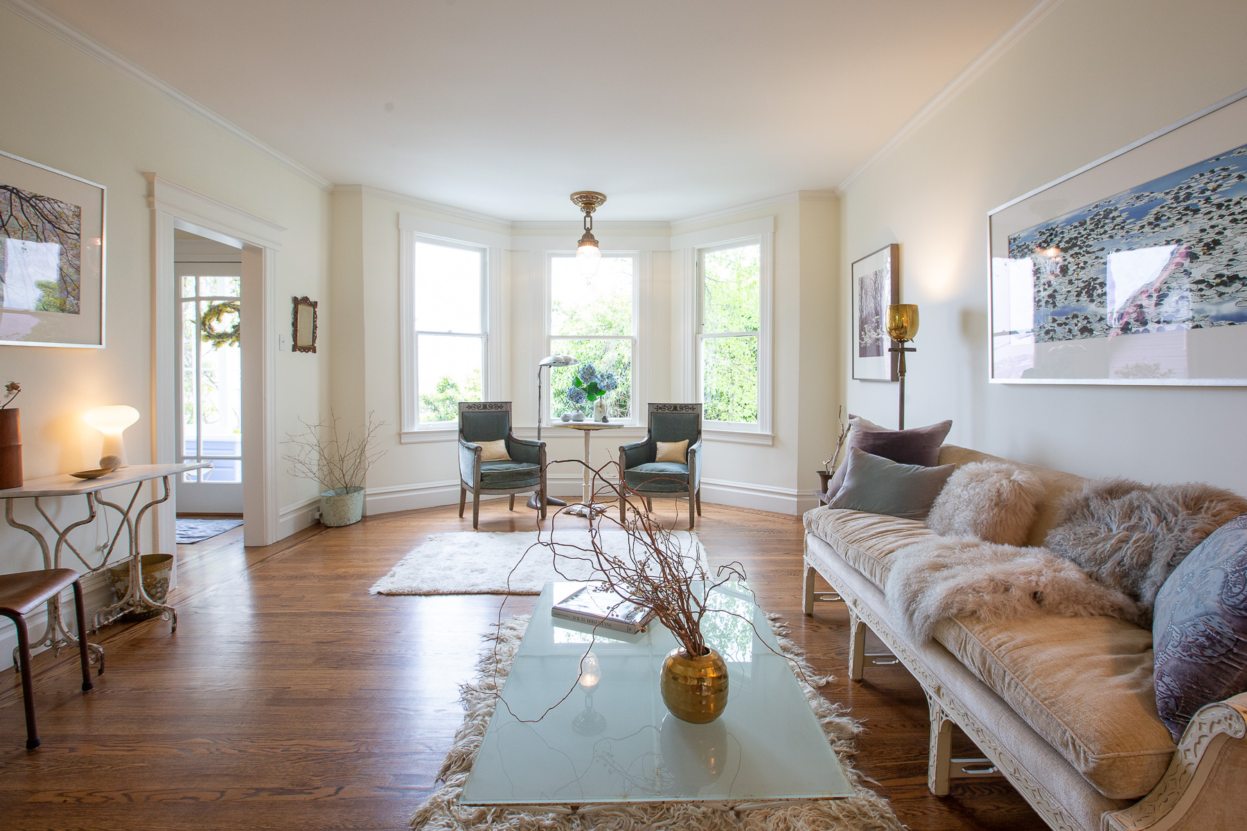 View of the living room, showing three large windows
